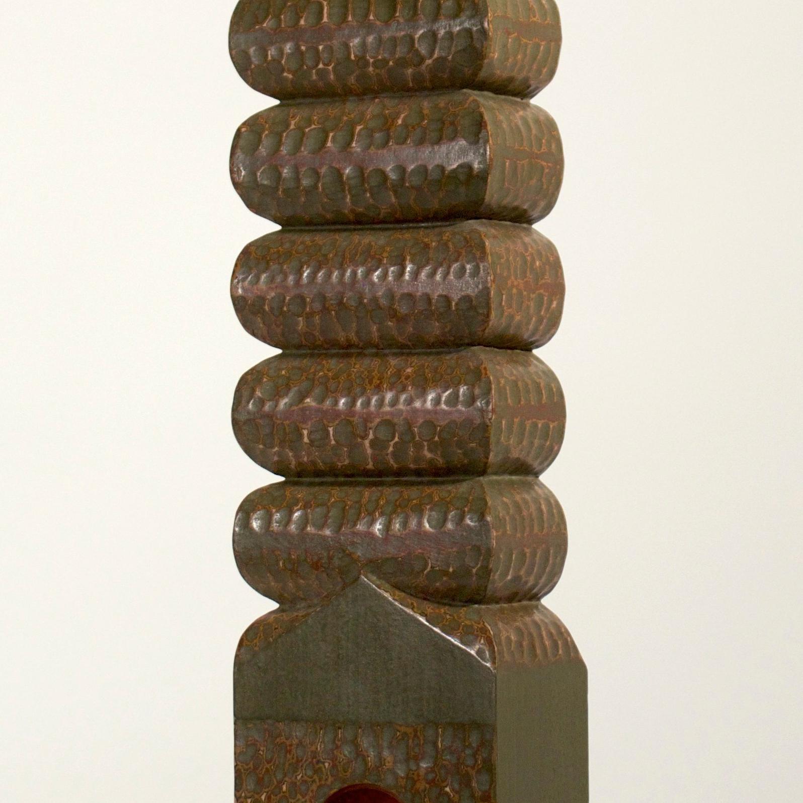 Philip Shore uses his art to illustrate man's relationship to the environment and how the connection between nature and culture is becoming more fractured. Spiraling Dreams is made of wood, cast iron, cast aluminum, silicone, fern frond, casein