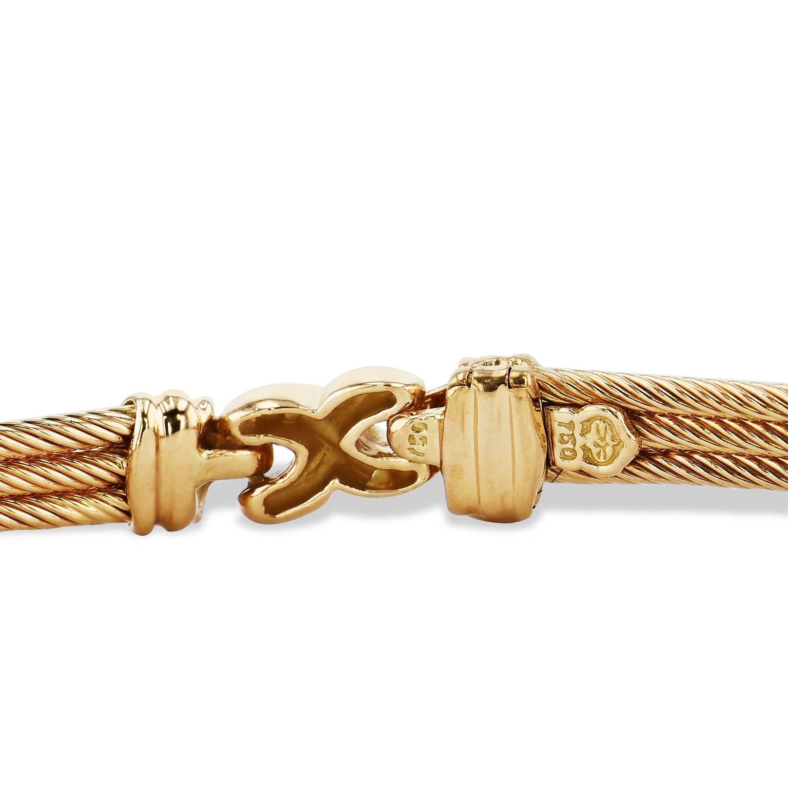 Enjoy this previously loved Phillipe Chariol 18 karat yellow gold choker featuring three rows of gold cable affixed by hinge with fifteen diamonds.