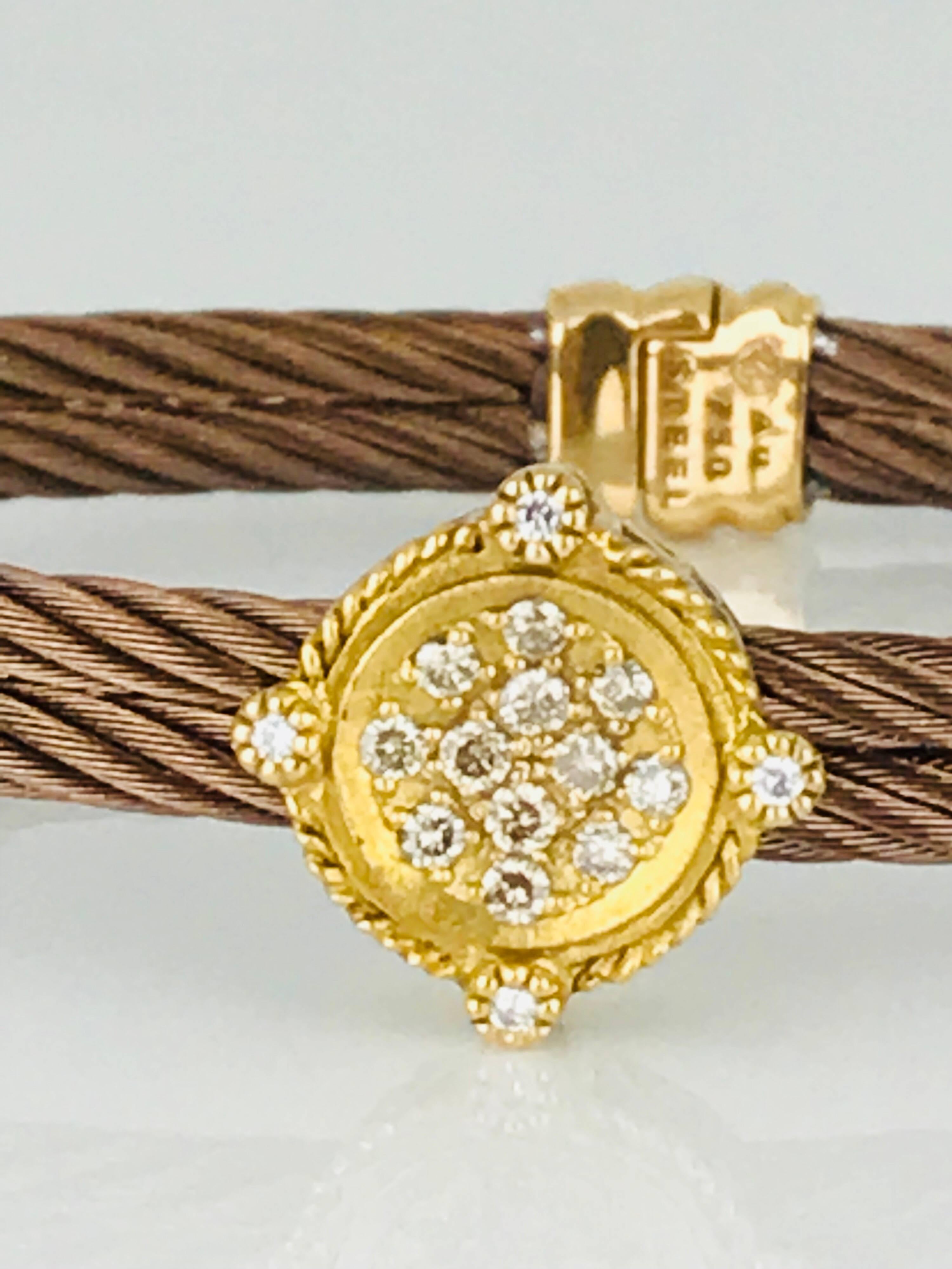 Phillipe Charriol designer, 18 Karat Yellow gold and stainless steel cable diamond bracelet. The stainless is a rich-copper color and the yellow gold is accented with diamonds. 
A total of (16) round diamond measuring 1.6 millimeters. The total