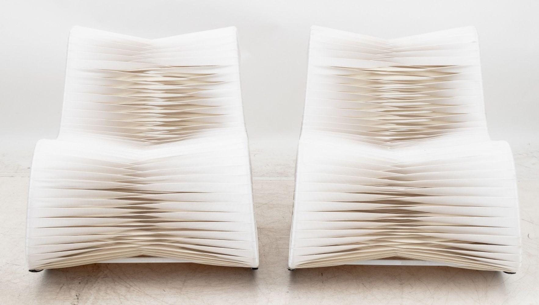 Pair of Phillips Collection White Seat Belt Rocking Chairs, designed by Nuttapong Charoenkitivarakorn. 31.75