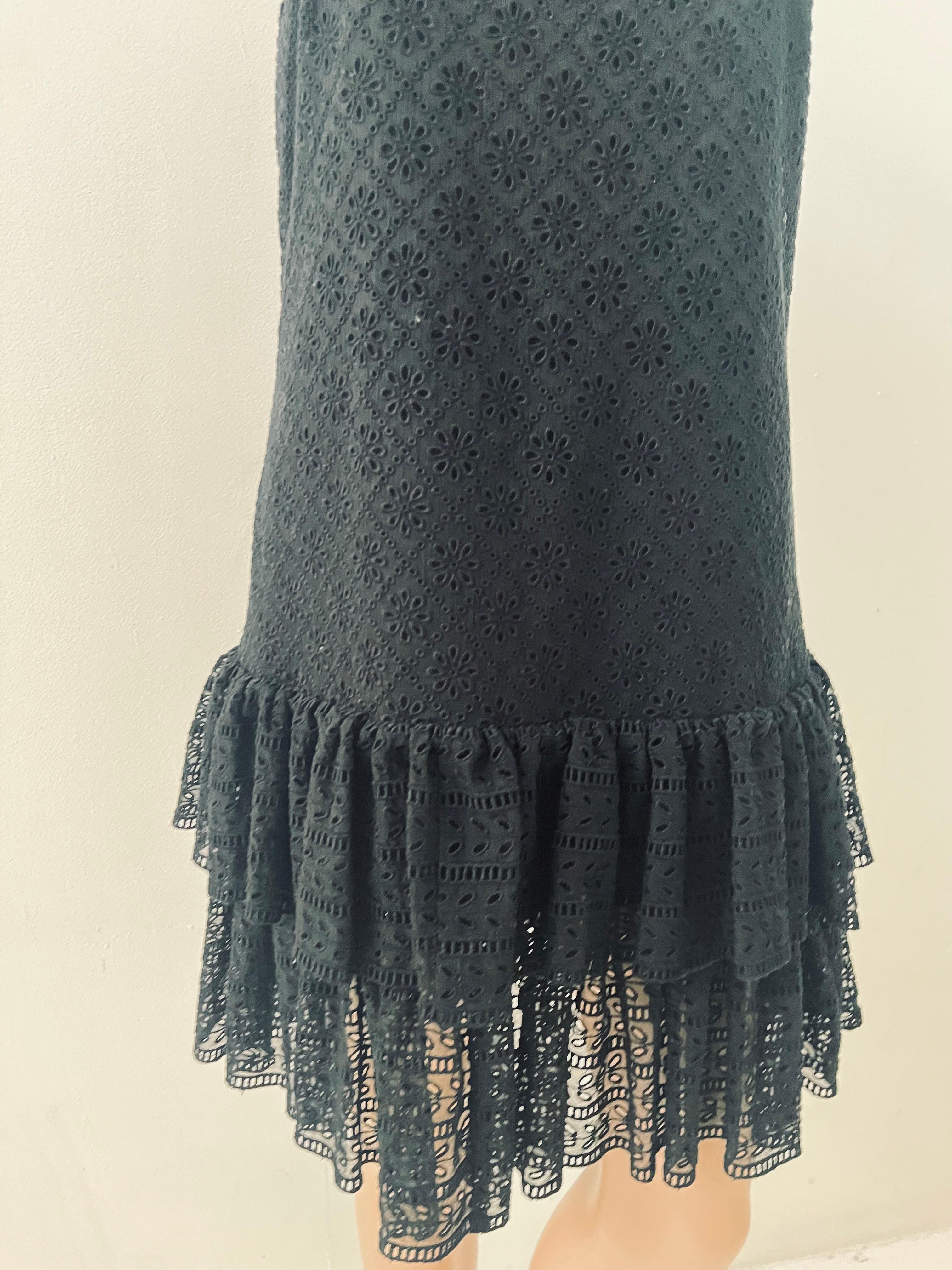 This refined and romantic black mini dress by Philosophy di Lorenzo Serafini showcases the designer’s signature blend of feminine charm and modern minimalism. Crafted in Italy from 100% polyester, it features an embroidered eyelet lace bodice and a