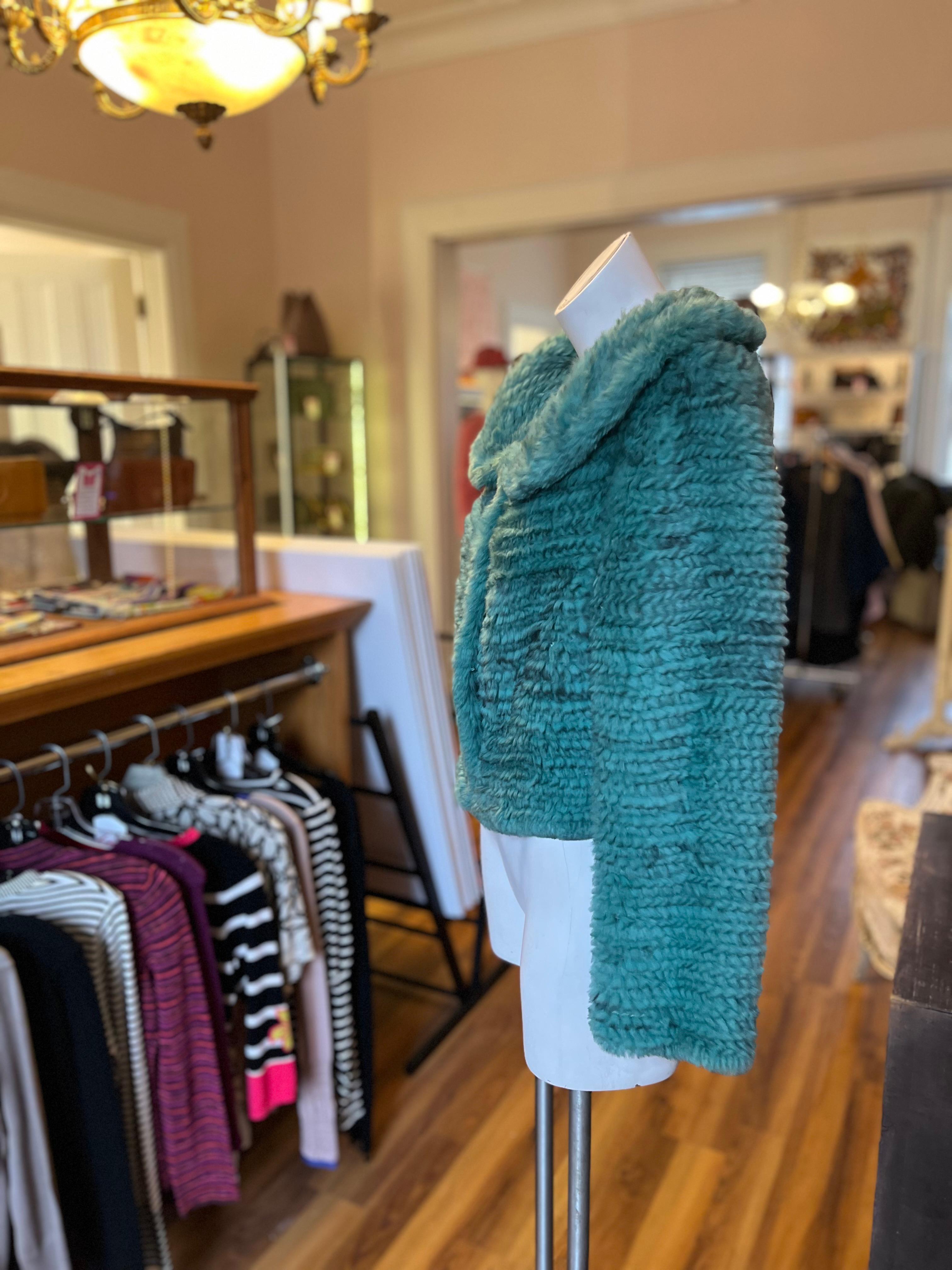 From the fashion house of Alberta Ferretti, this is a Philosophy di Alberta Ferretti knitted rabbit fur jacket in a beautiful vivid green.
The jacket has a rounded collar; three eyes and hooks for closure; long generous sleeves, and it tapers at the