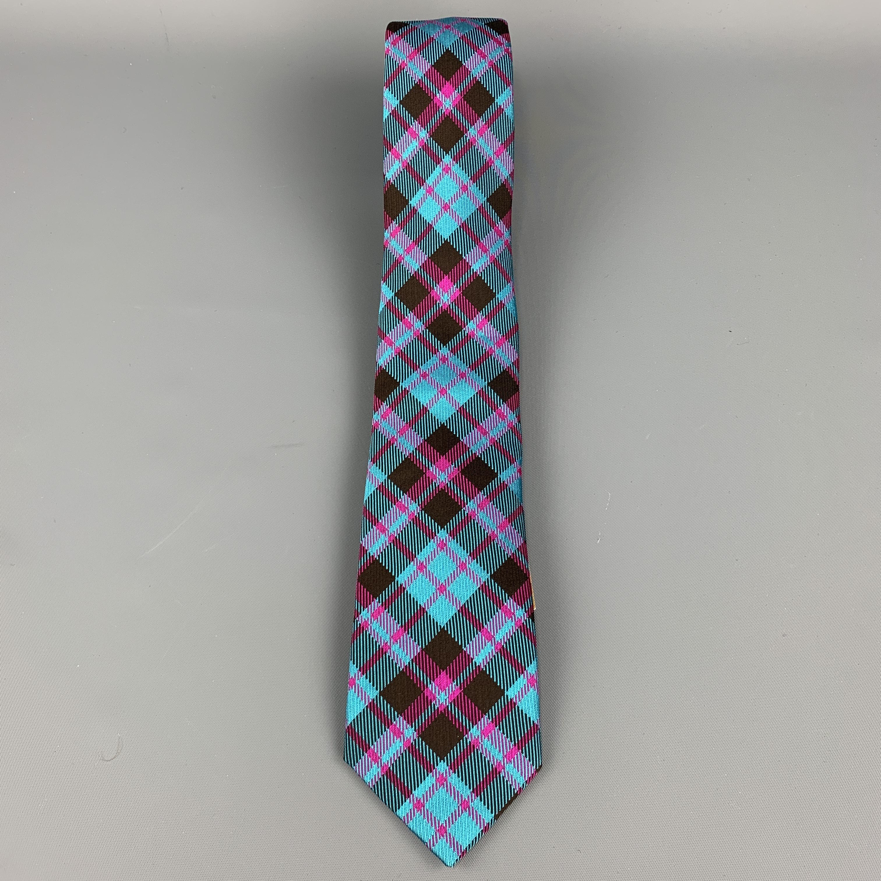 PHINEAS COLE skinny necktie comes in aqua blue silk twill with all over pink and brown plaid print. Made in England.

New with Tags. 

Width: 2.75 in.