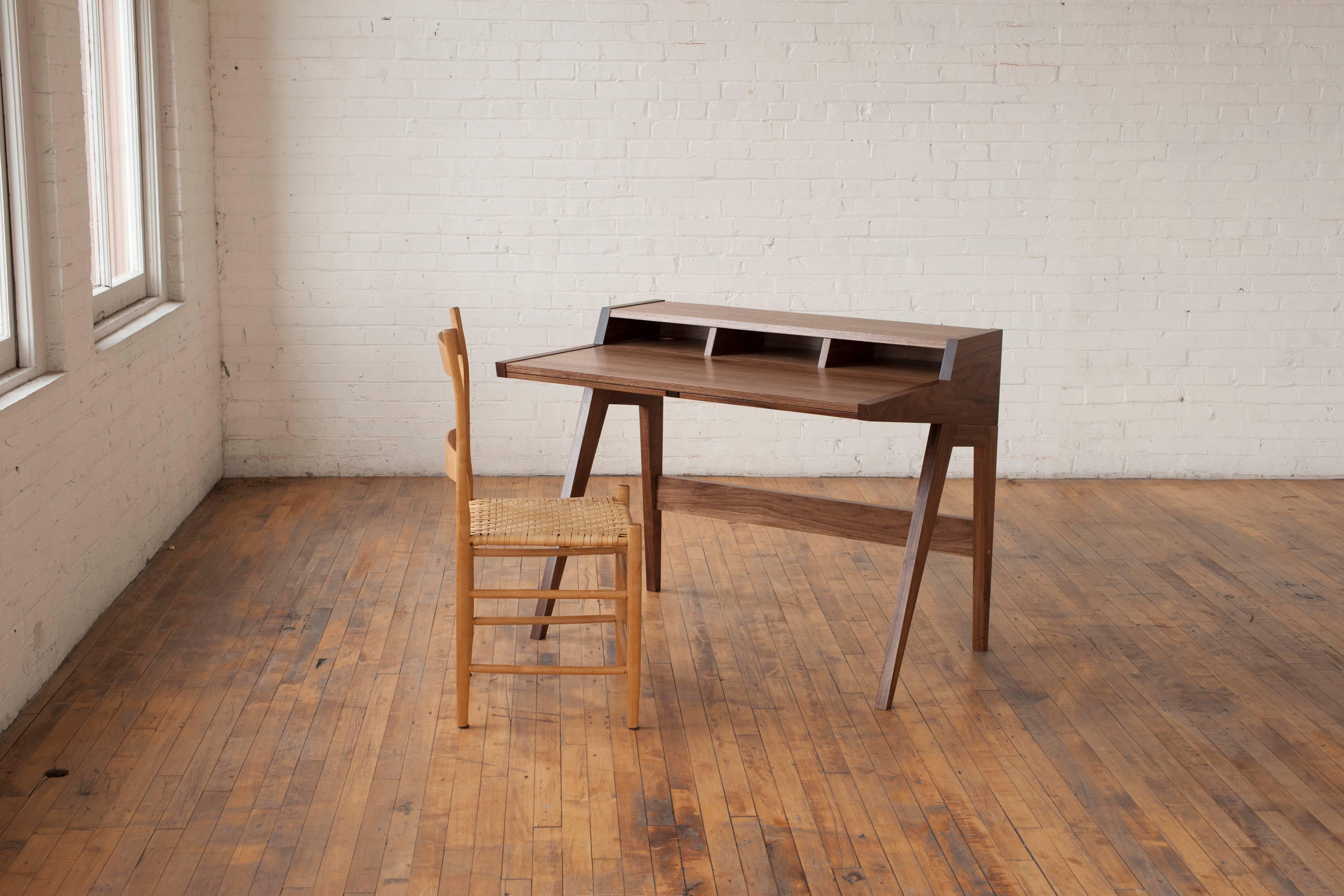 Phloem Studio Laura desk is a modern contemporary solid wood secretary desk, handmade custom to order for home or office. With a minimal footprint, the table has ample surface for a laptop and writing space. The desk has two tapered tray drawers