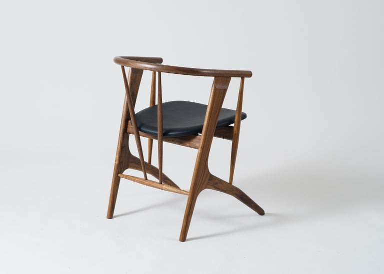 Phloem Studio Zoe chair is a modern contemporary solid wood armchair handmade custom to order. Zoe is a highly crafted, highly comfortable lightweight armchair designed for long dinner parties or a working late. The angled solid steam bent back