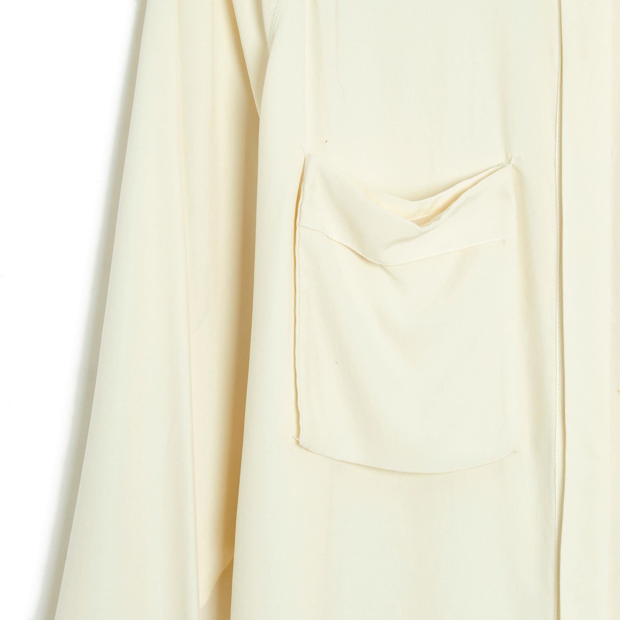 Céline top by Phoebe Philo blouse in ecru silk crepe, classic collar, hidden button placket, 2 chest pockets attached to the 4 corners (only), shirt bottom, back pleat, long buttoned raglan sleeves. Size 36FR (perfect in 38FR): middle 38 cm, chest