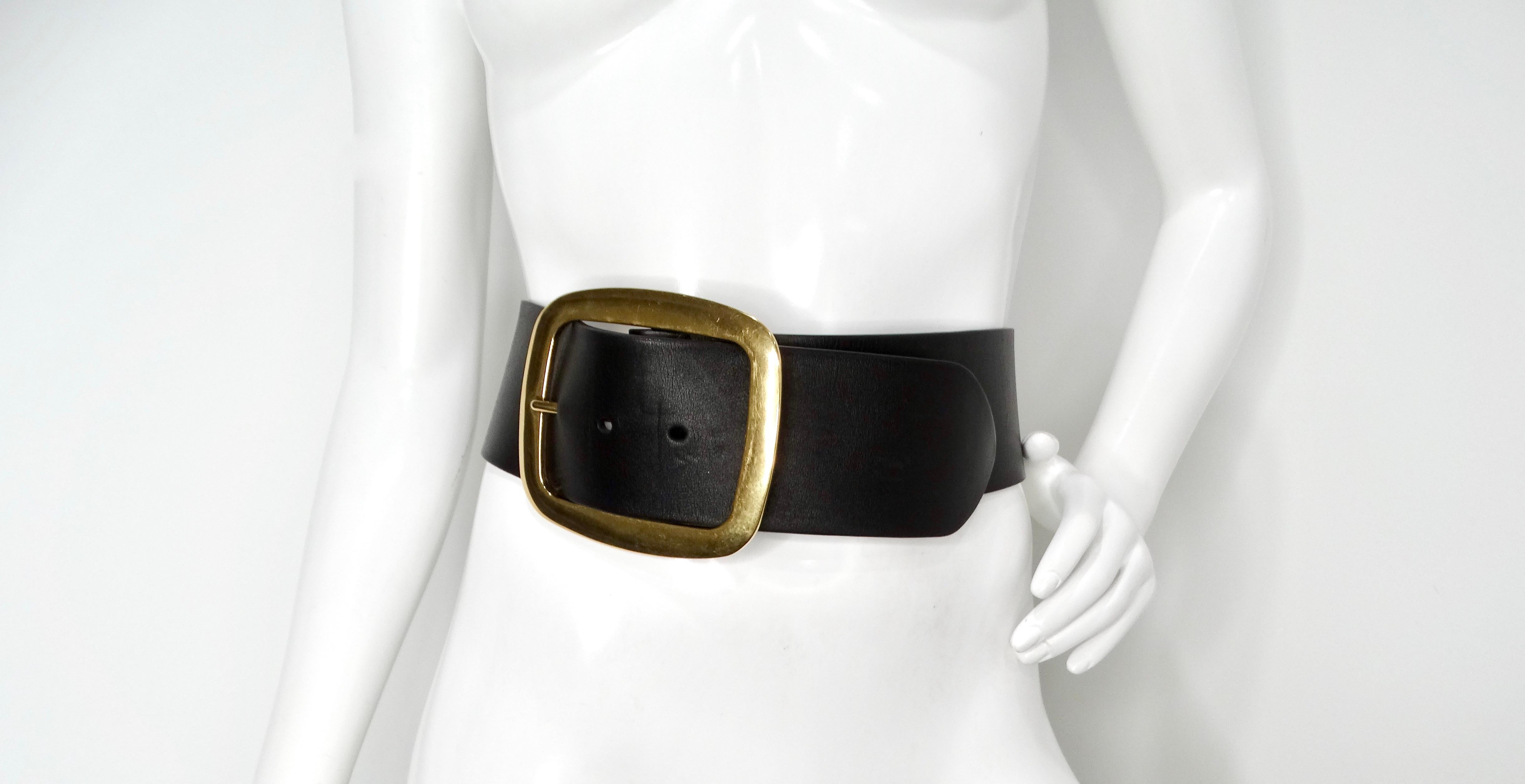 Elevate your fashion game with the Phoebe Philo for Celine 2012 Large Leather Gold Plated Brass Buckle Corset Belt, an exquisite piece that combines bold design with timeless elegance. This statement belt is crafted from high-quality black leather,