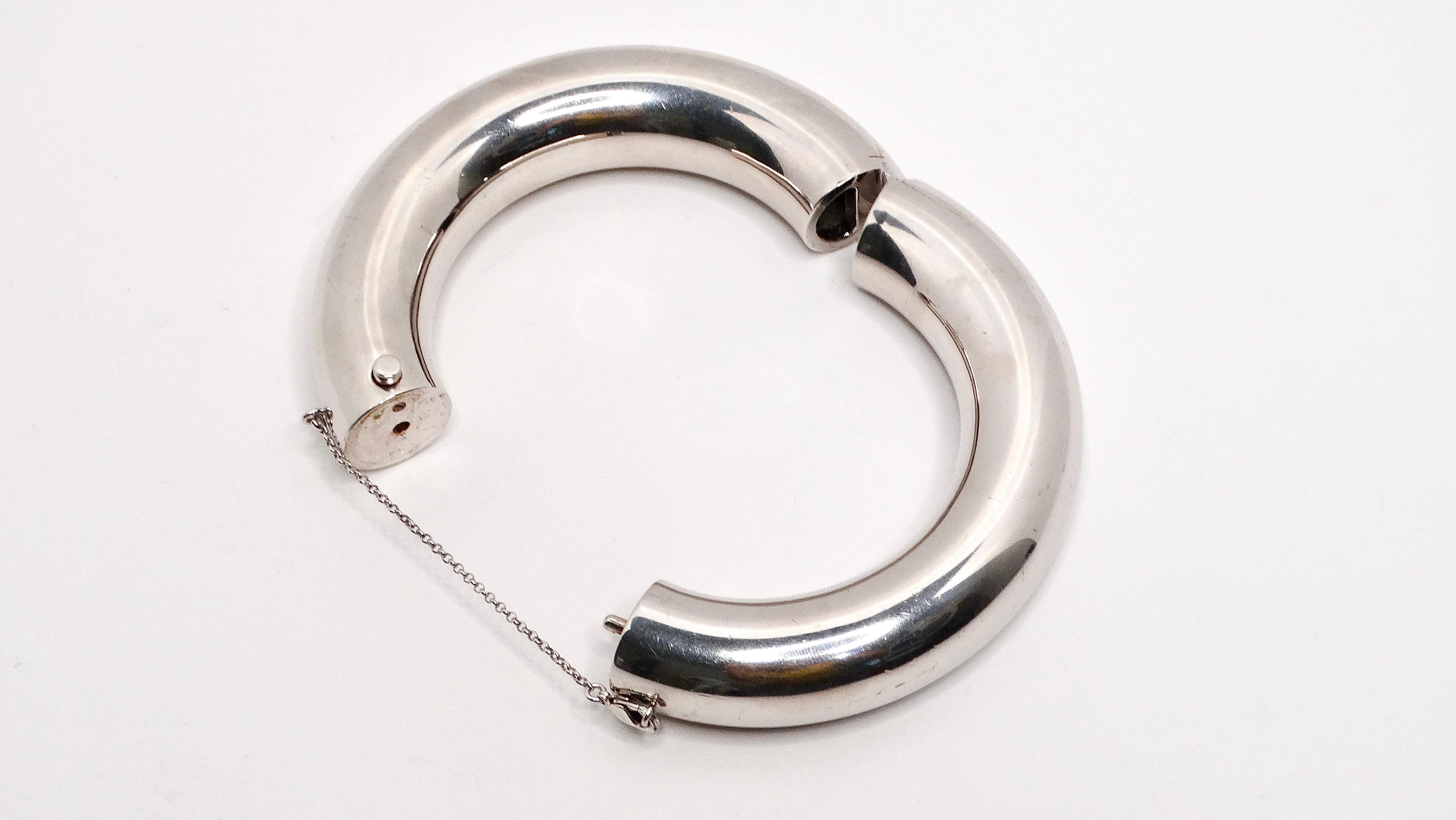 The Phoebe Philo for Celine Palladium Plated & Brass Bangle is a stunning piece that reflects the designer's signature minimalist and sophisticated style. This thick tubed bangle, plated in sleek palladium and crafted from brass, opens gracefully at