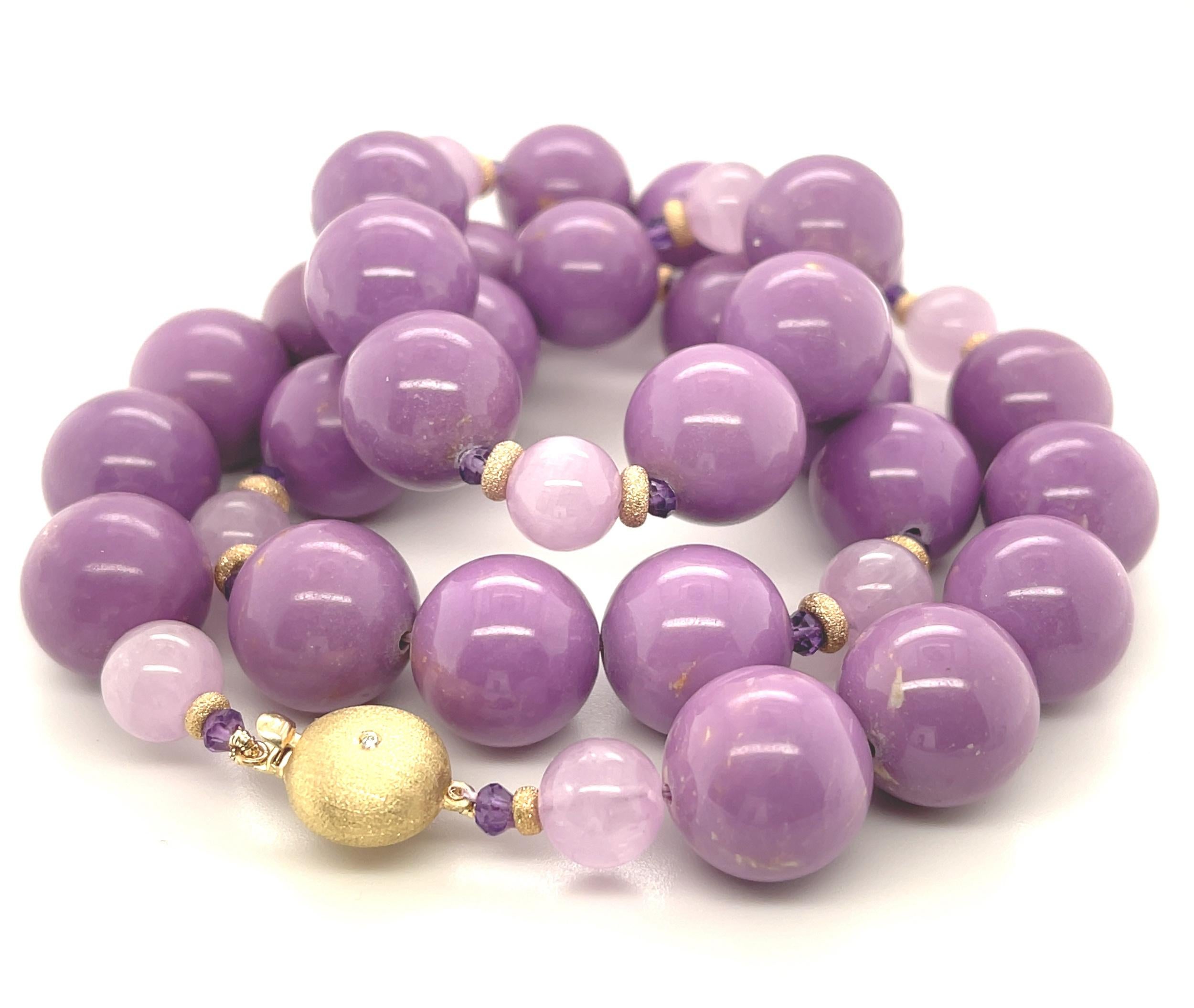 This beautiful and unusual necklace features a gorgeous collection of luscious purple phosphosiderite beads, elegantly arranged with pink kunzite beads, royal purple amethyst, and textured yellow gold accents! The large phosphosiderite beads measure