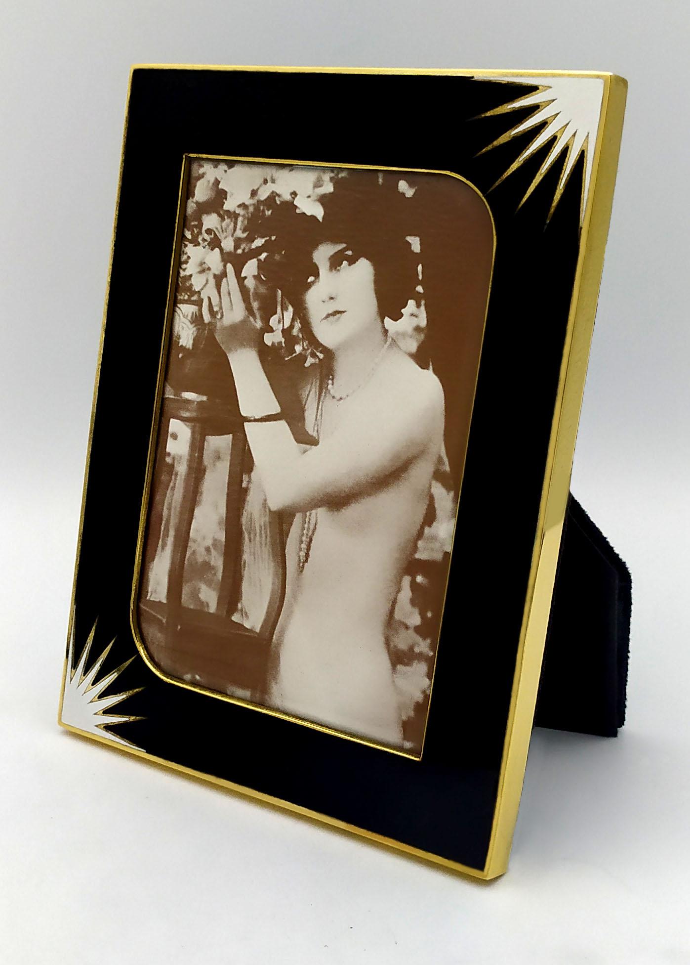 Black with white milk design Rectangular photo frame in 800/1000 silver gold plated with fire enamels. External cm. 13.4 x 17.4 Internal cm. 9 x 13. Weight gr. 199. Created in Art Deco style for Cartier USA in the 1980s, inspired by drawings by