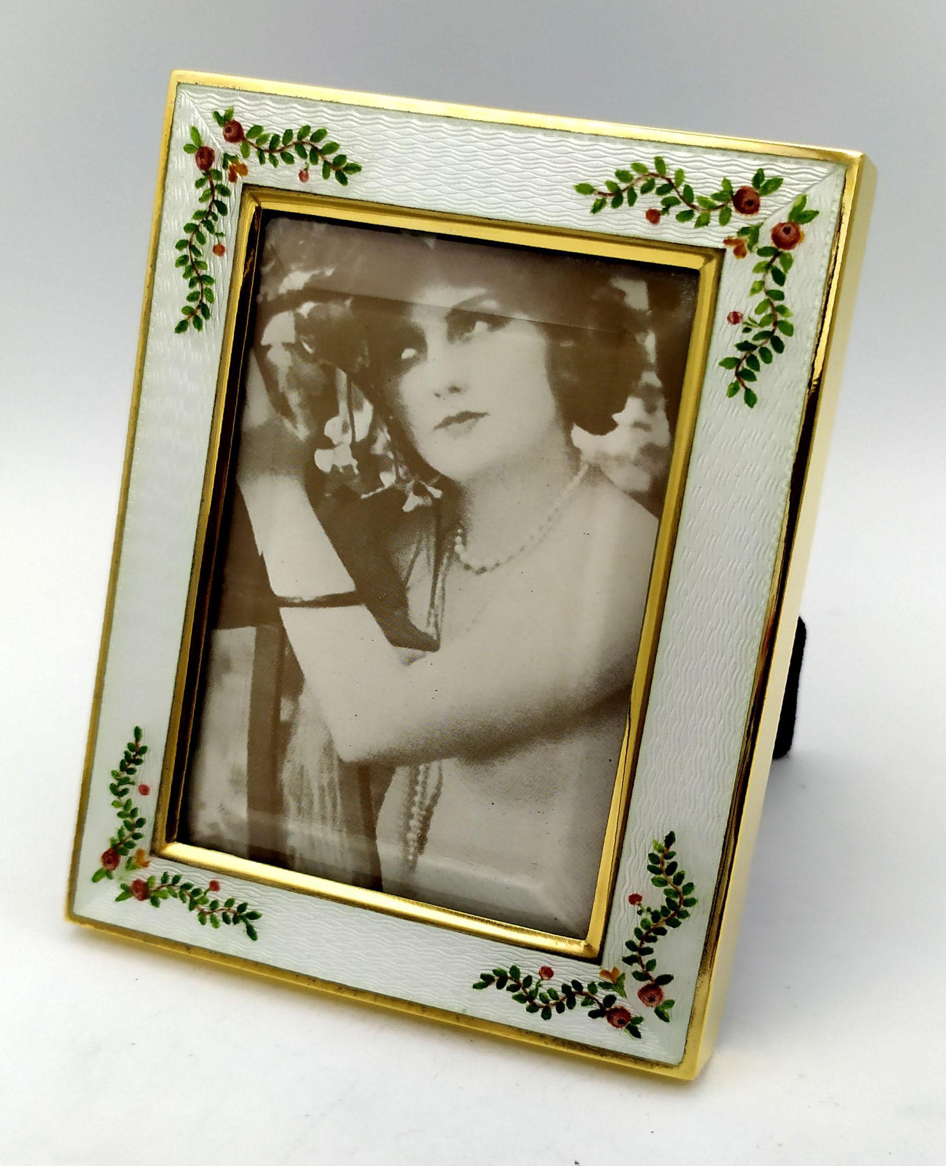 Photo Frame rectangular in 925/1000 sterling silver gold plated with translucent enamel fired on guilloche and hand-painted miniature of late 19th century Viennese Art Nouveau style flower garlands. External measurements cm. 8.8 x 11.8 internal cm.