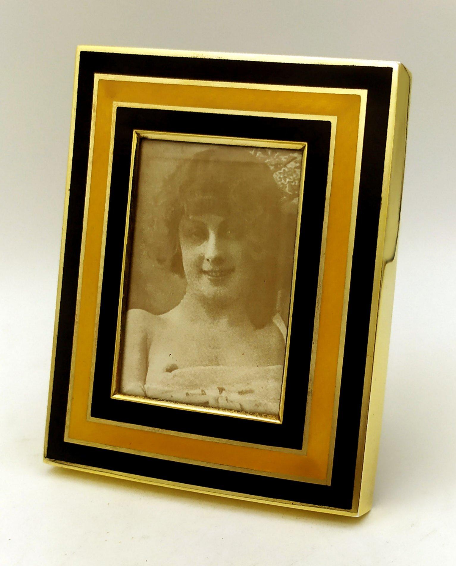 Rectangular photo frame in gold plated 925/1000 sterling silver with translucent fired enamels on two-tone striped guillochè. In a contemporary style. Ground glass and velvet panel. External measurements cm. 10 x 12. internal cm. 5 x 7. Weight gr.