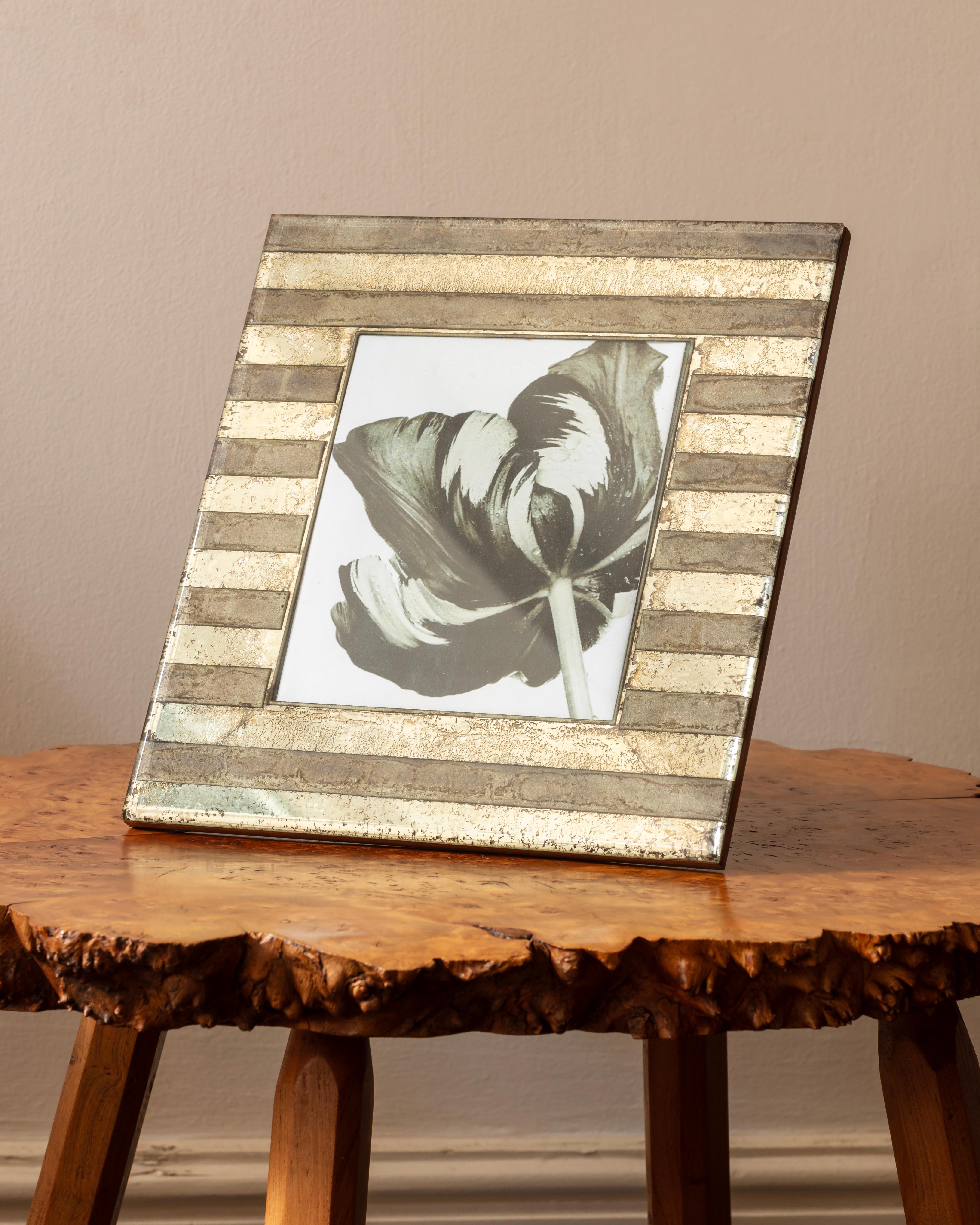 Photograph frame, stripes of distressed mirror mounted on sycamore.
Italian 1940s 
Dimensions: H:29cm x W:31cm