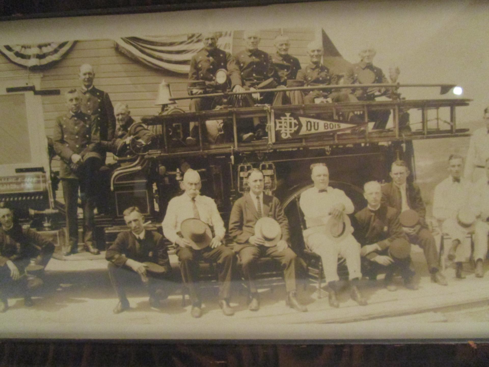 Large black and white panorama photograph featuring forty-six members of the J.E. DuBois Hose Company pictured with their Bureau of Fire, DuBois, PA firetruck. Dated August 17, 1922. Framed in old three quarter inch wooden frame, probably the