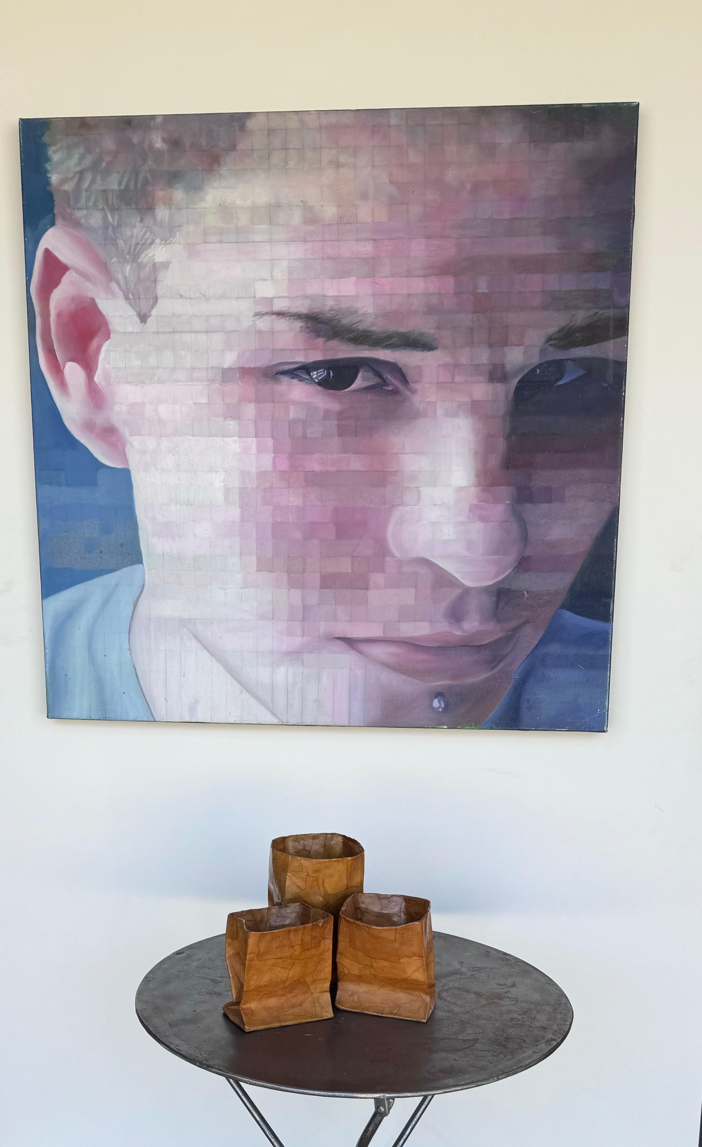 Large acrylic on canvas portrait of a young man with a facial piercing, featuring mosaic like cells that were popularized by the world renowned artist Chuck Close. The reverse bears the name Chris in pencil. Measuring 34” square