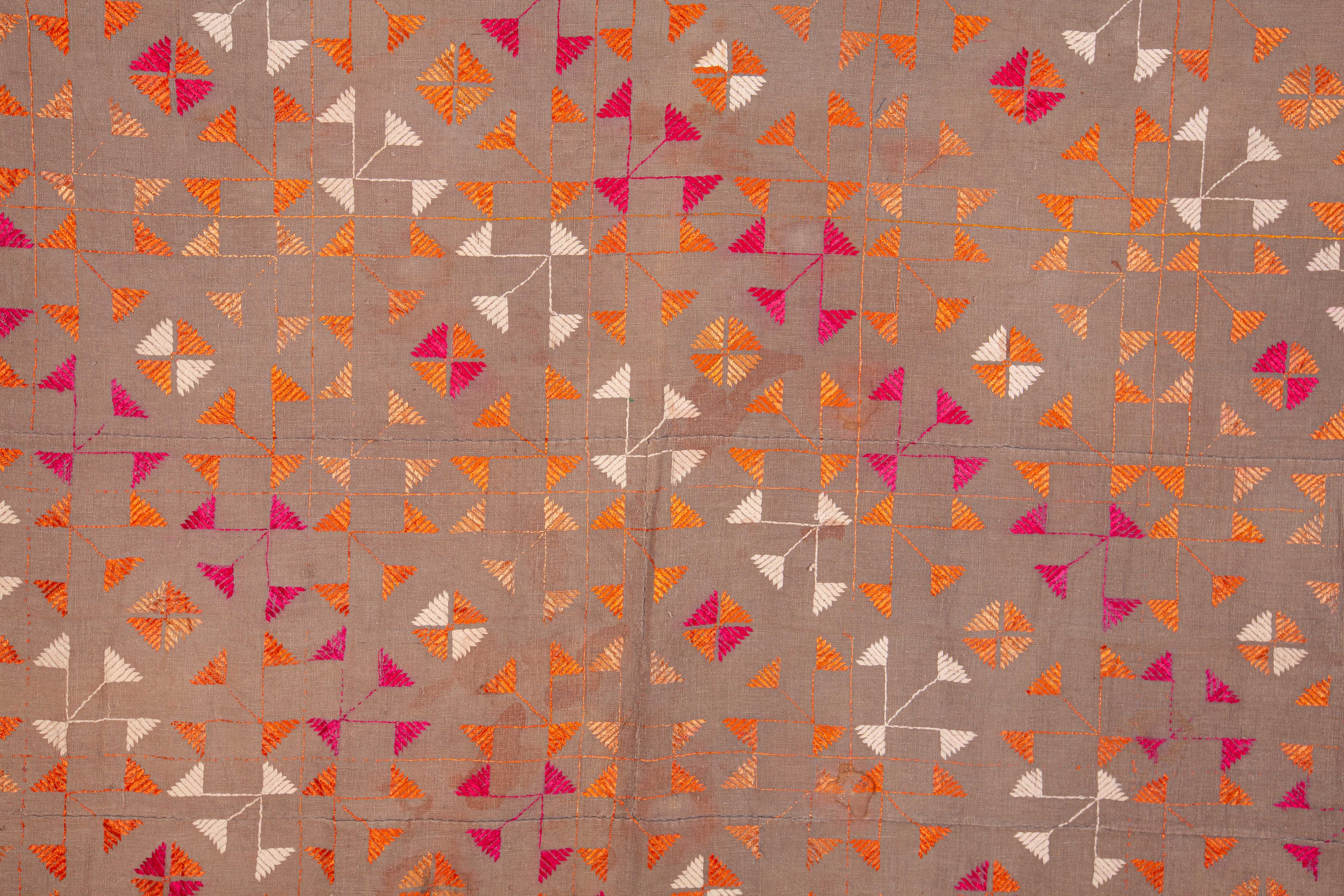 Silk embroidery on a hand loomed cotton fabric.