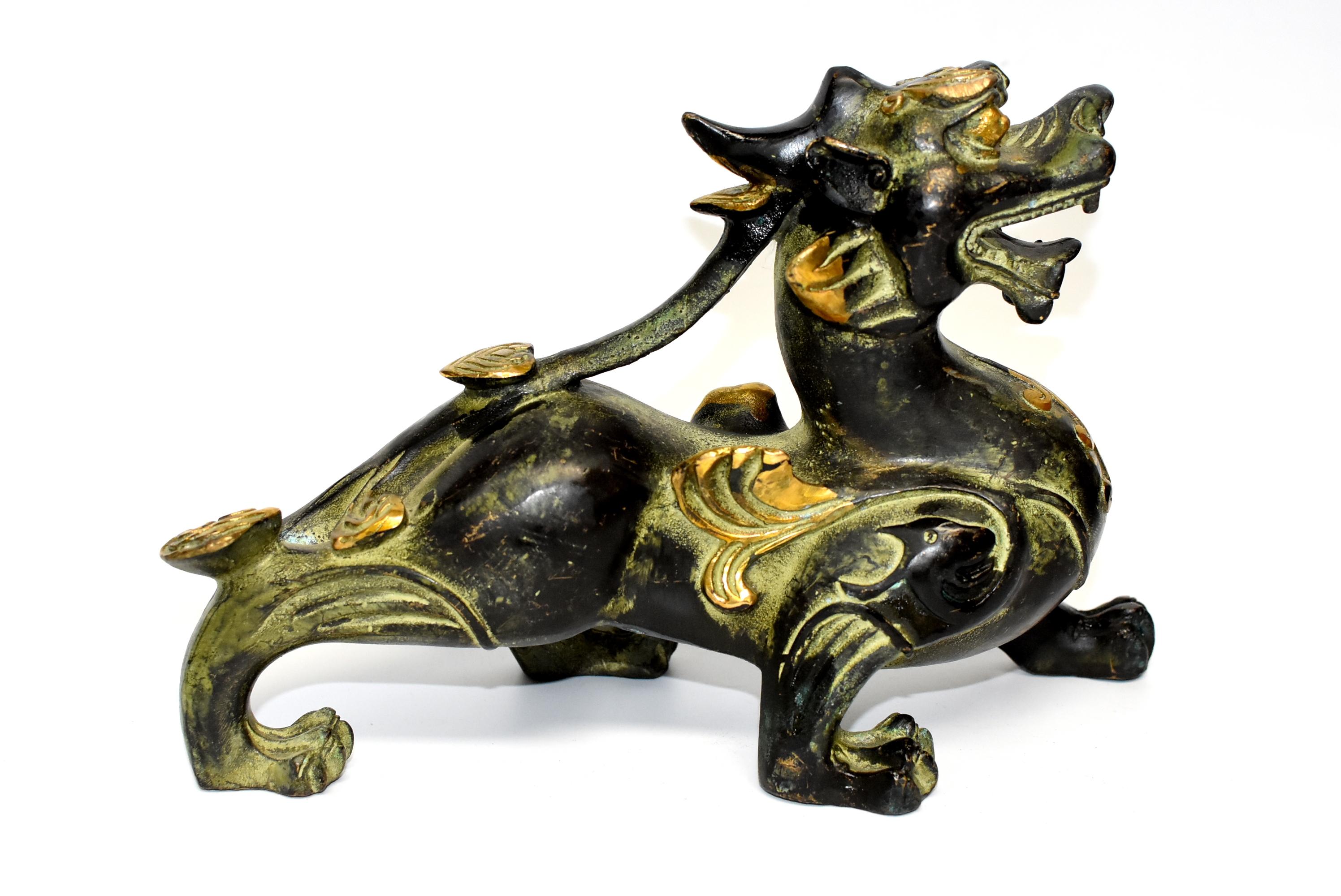 A pair of large, hefty bronze Pi Xiu statues. These mythical animals are the Chinese treasured money beast who is believed to bring and hold wealth. Beautiful gilding highlights the beasts, giving them a fantastic auspicious glow. Besides being a