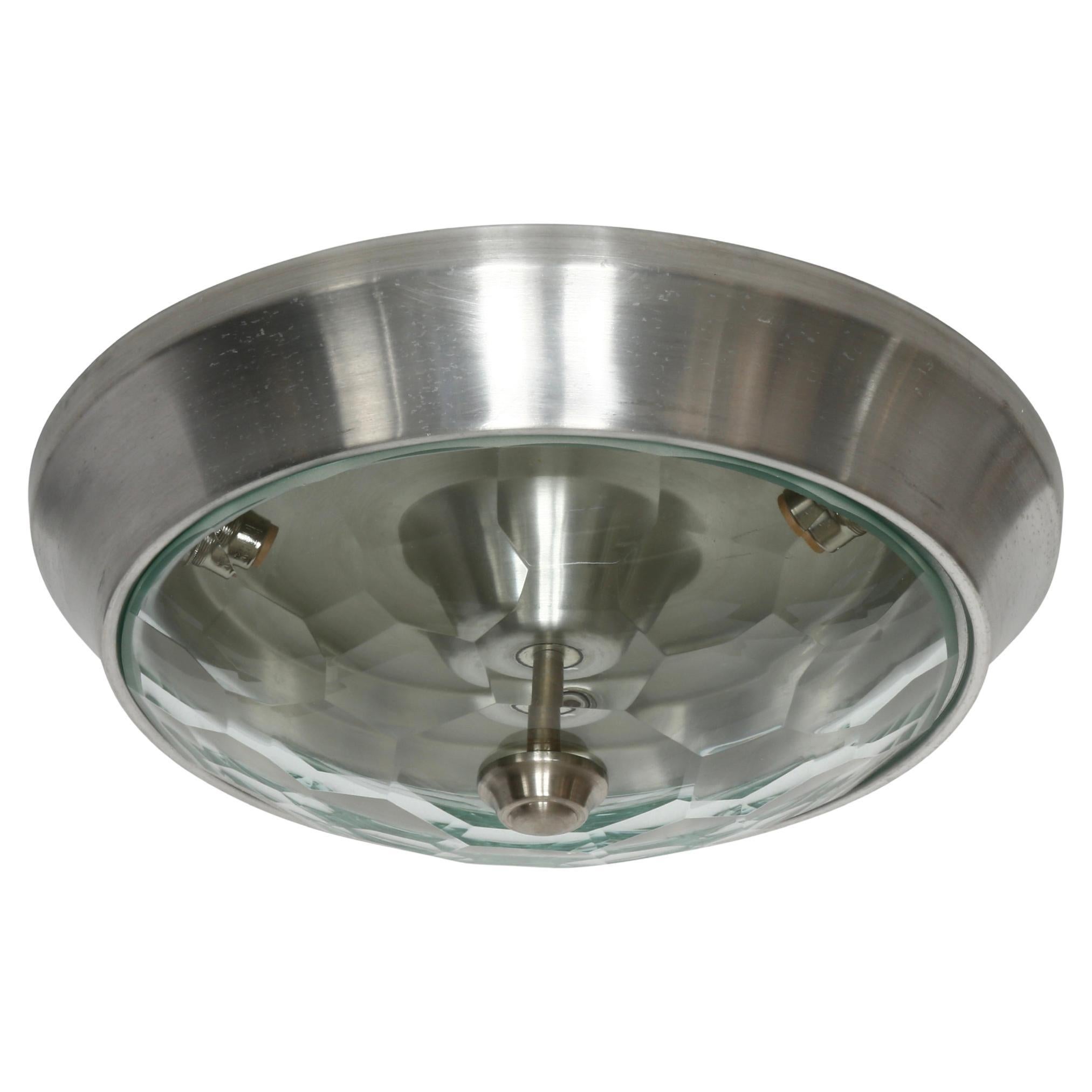 Pia Guidetti Crippa for Lumi flush mount ceiling light
Made in Italy, 1960s
Faceted glass shades, aluminum frames.
Takes 3 candelabra sockets. 
Complimentary US rewiring upon request.
Price is for one light.

We take pride in bringing vintage