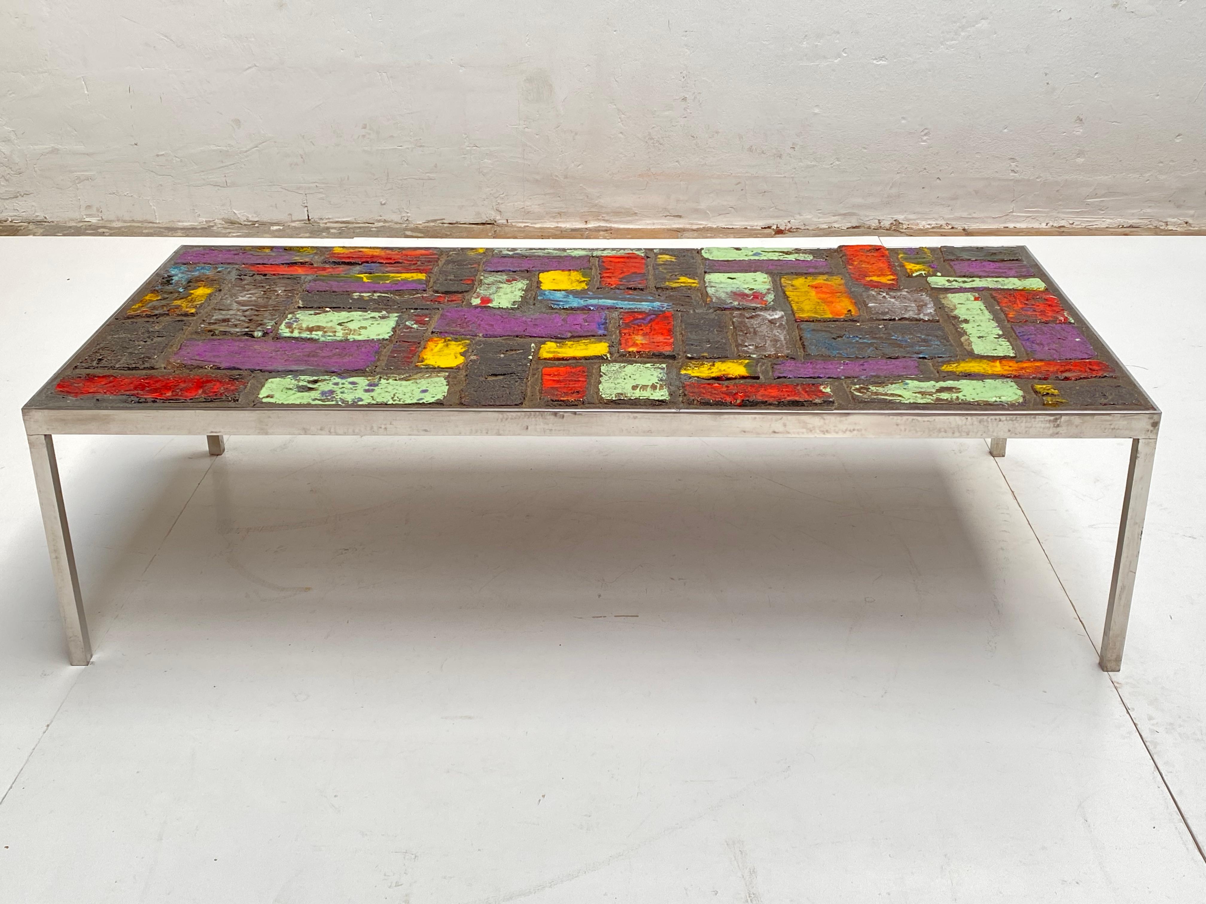 Very bright and colourful Brutalist coffee table by Pia Manu 

Solid chromed steel frame with ceramic top that looks like an abstract painting

The table is not signed or marked but the quality of this work only points to the famous Pia Manu