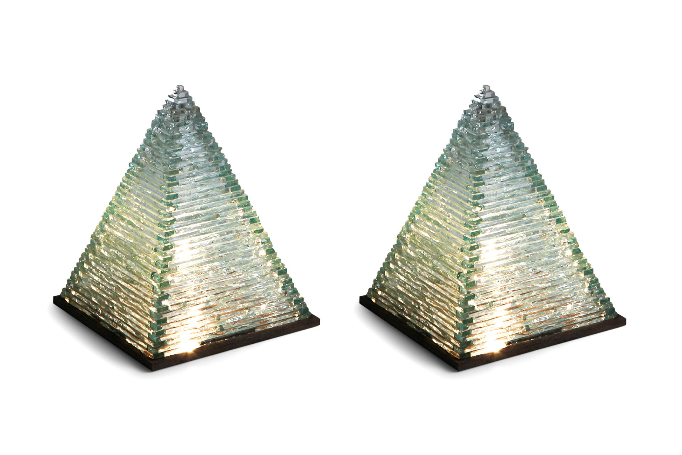 Postmodern Pia Manu pyramid shaped lamps in glass
One-off lighting pieces created by Jules Dewaele in a modern Brutalist style.
The lamps are absolutely stunning pieces of work
multiple layers of glass built up in a pyramid shape, mounted on a