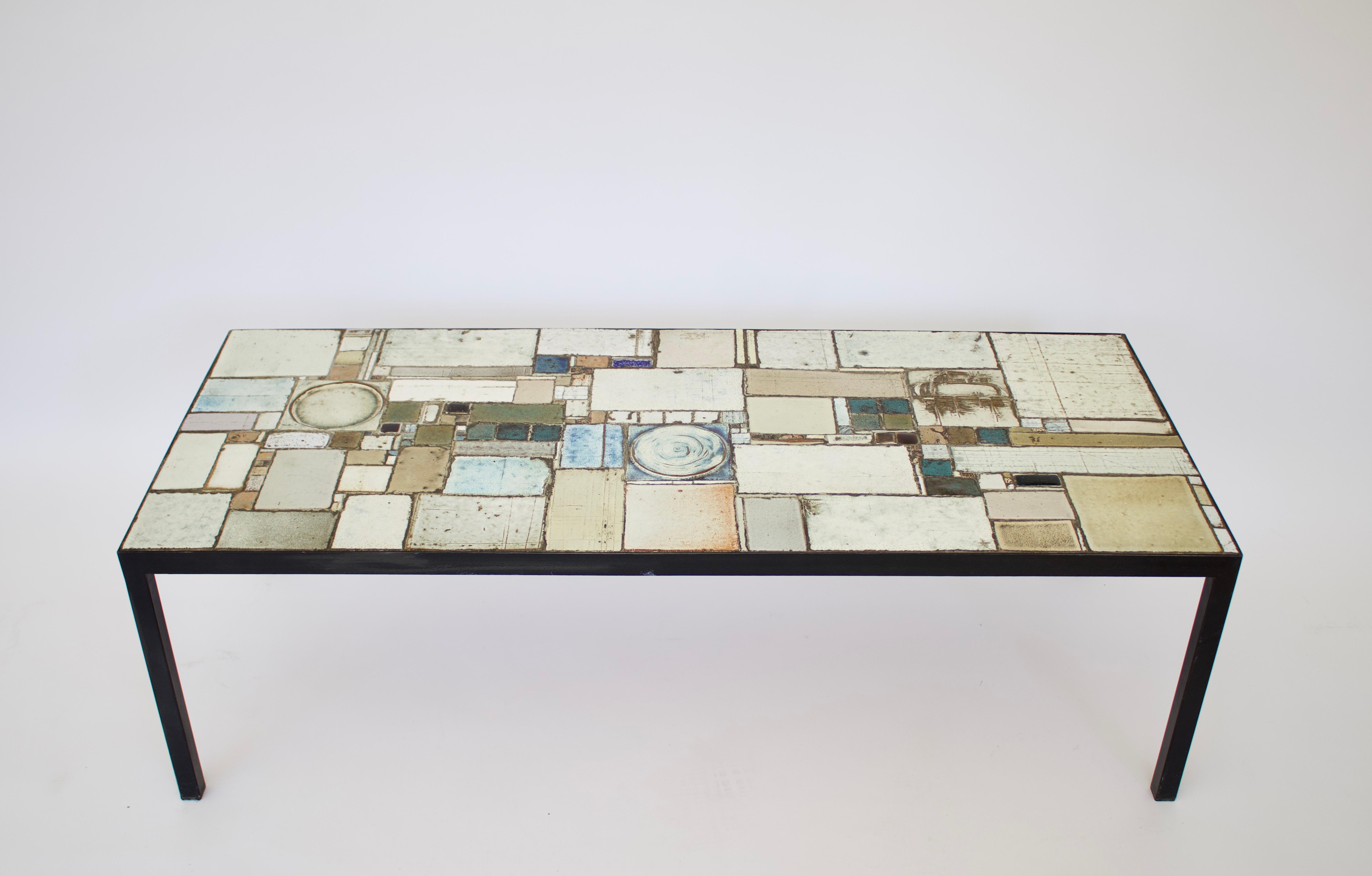 Pia Manu signed ceramic mosaic coffee table. Pia Manu, a Belgian artist often collaborated with Amphora ceramic company who created ceramic tiles for his creations. 
Belgian sculptor and designer, Pia Manu Is related to Flemish brutalists. He