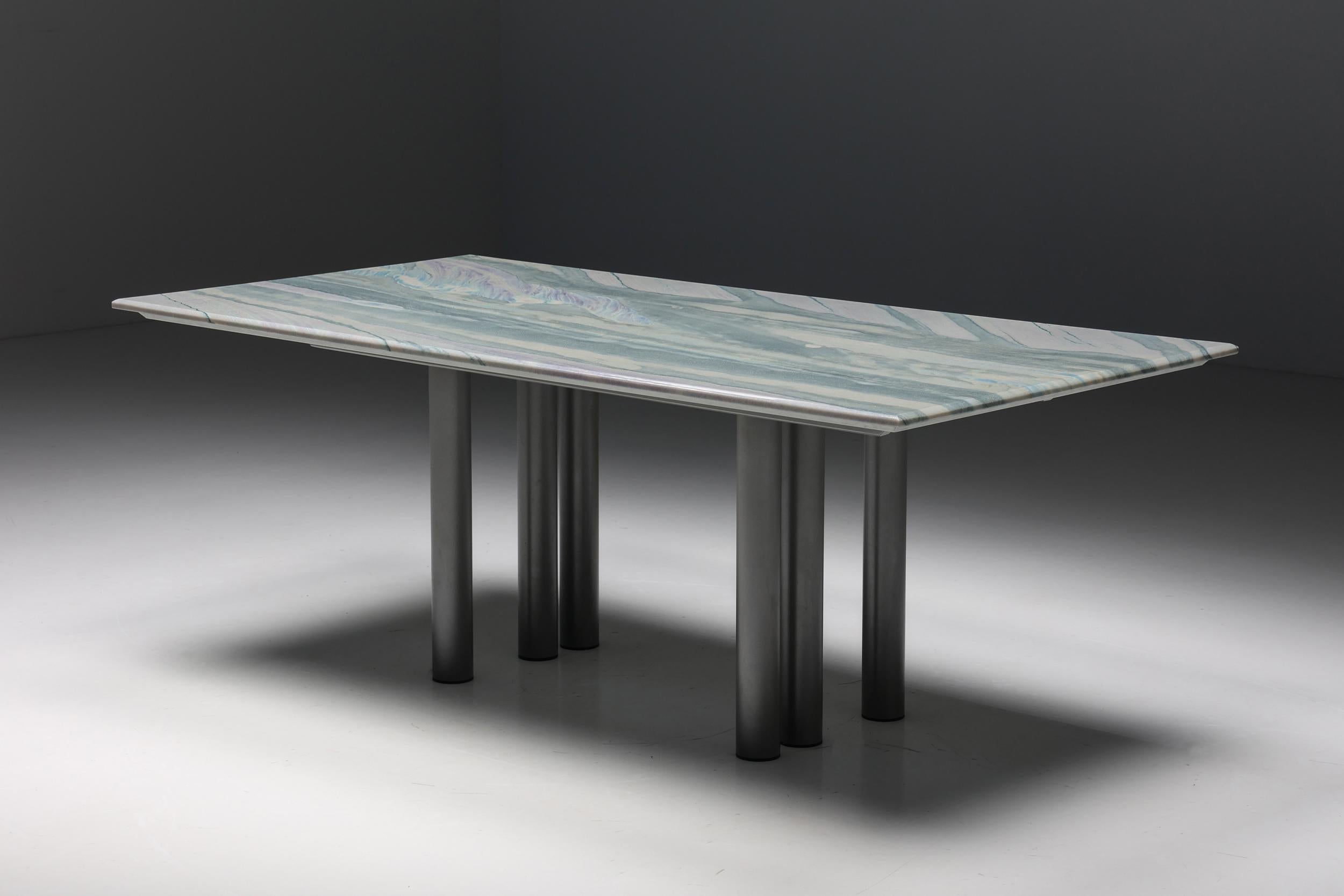Pia Manu Dining Table in Marble & Steel, 1990s

Belgian post-modern marble sculptural dining table created by Pia Manu in the 1990s. A sculptural design featuring six cylindrical steel legs and a marble tabletop. The marble shows beautiful veins