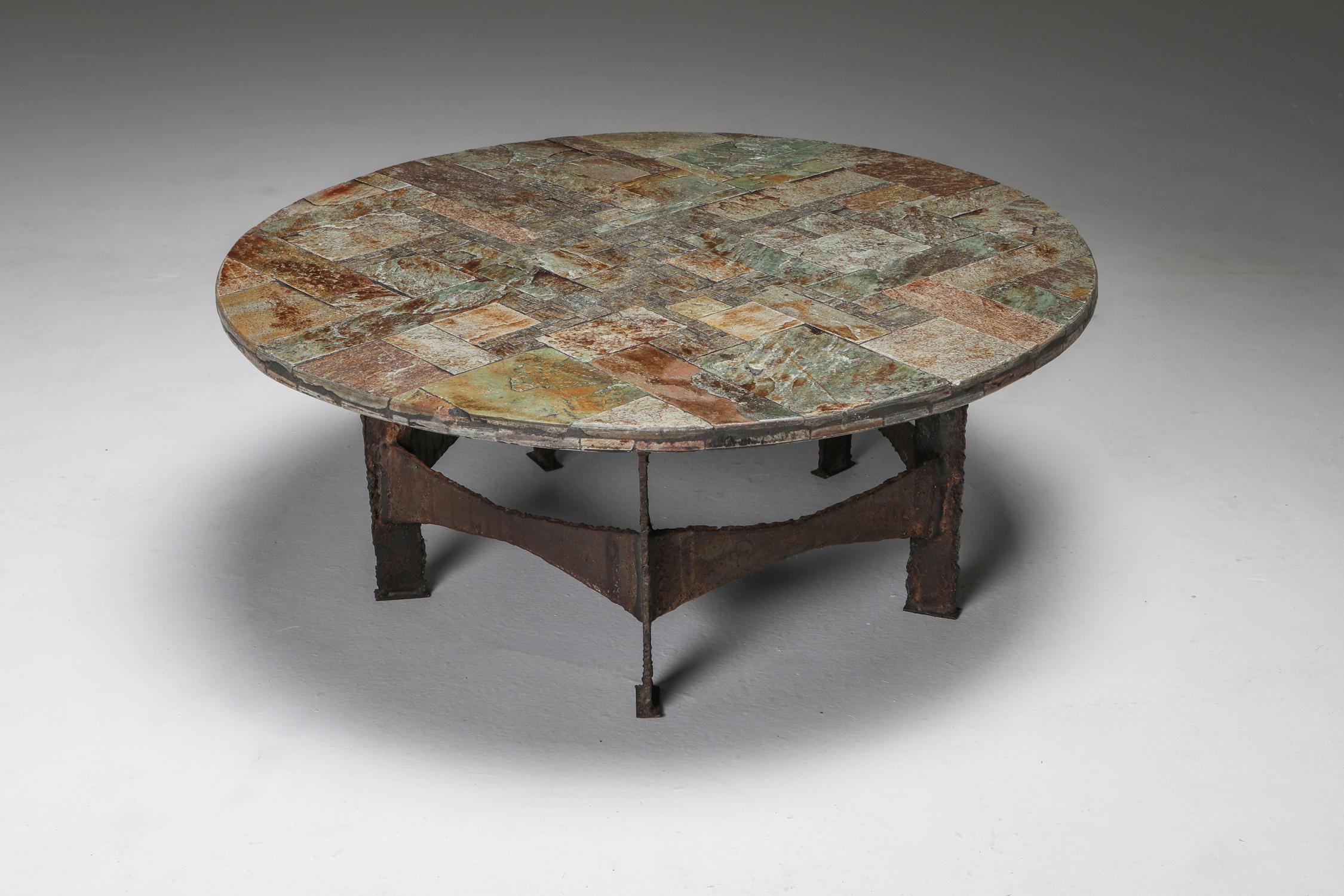 Pia Manu, coffee table, slate, iron, Belgium, 1970s.

Brutalist cocktail table by Pia Manu. The tabletop is a beautiful slate mosaic.
Displaying a variety of complementary natural colors, from pink to gold and green.

This piece has a very wabi