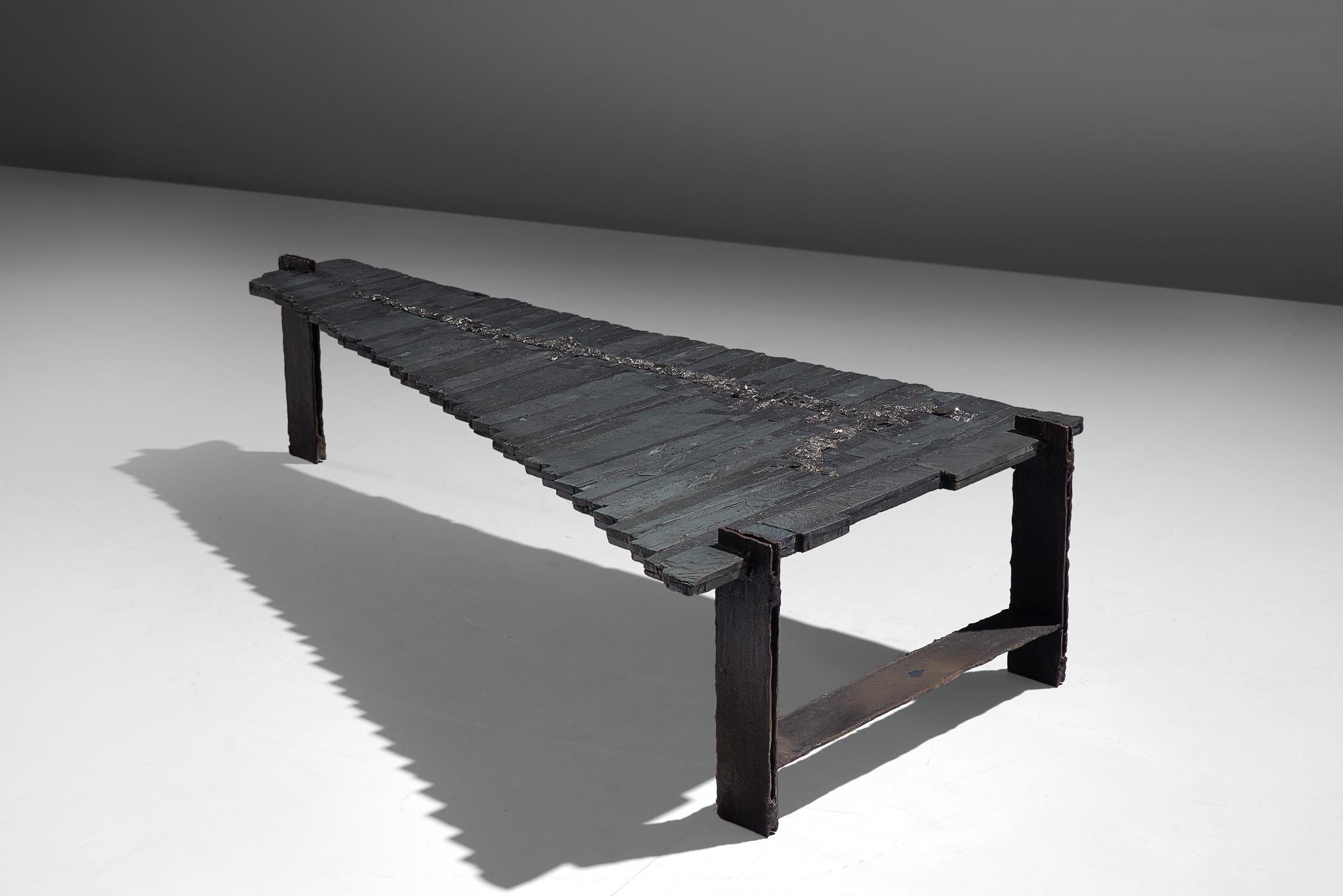 Pia Manu, coffee table, slate, iron and pyrite Belgium, 1970s.

One of a kind brutalist cocktail table by Pia Manu. The table top consists of long piece of slate of differnet lengths, positioned in a row. The top is inlayed with an abstract