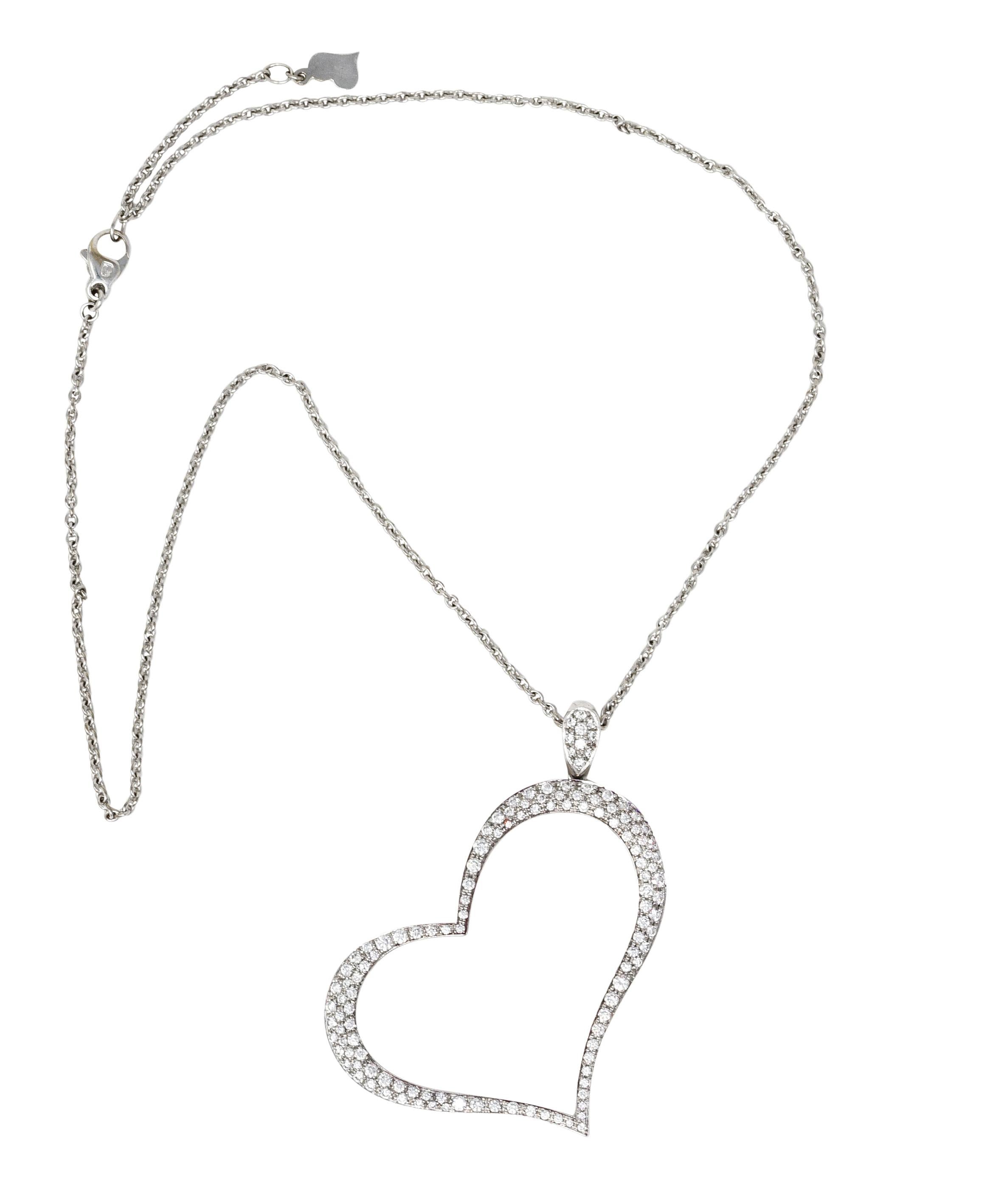 Curb chain necklace suspends a large open heart pendant. Pavé set throughout by round brilliant cut diamonds. Weighing in total approximately 1.53 carats - G to I color with VS clarity. Completed by lobster clasp and logo link heart. Chain and