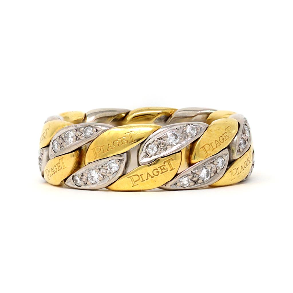 A signed Piaget Diamond and 18K gold duo tone chain ring size 9, circa 1990. Crafted in Switzerland during the later years of the 20th century, this chain ring is all about subtle contrasts, between the intertwined 18K yellow and white gold, adorned