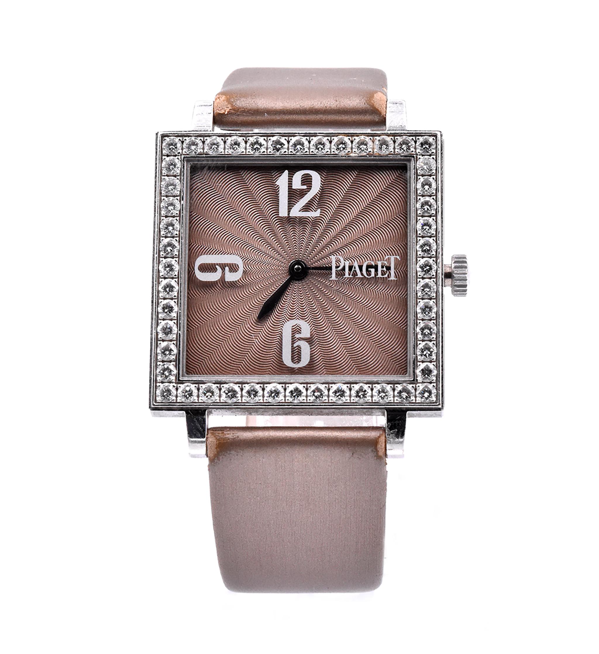 Movement: quartz
Function: hours, minutes
Case: 30.25 X 30.25mm white gold square case set with 2.00cttw diamond bezel, scratch resistant sapphire crystal, push/pull crown
Band: brown silk strap with 18K white gold Piaget Buckle
Dial: brown sunburst