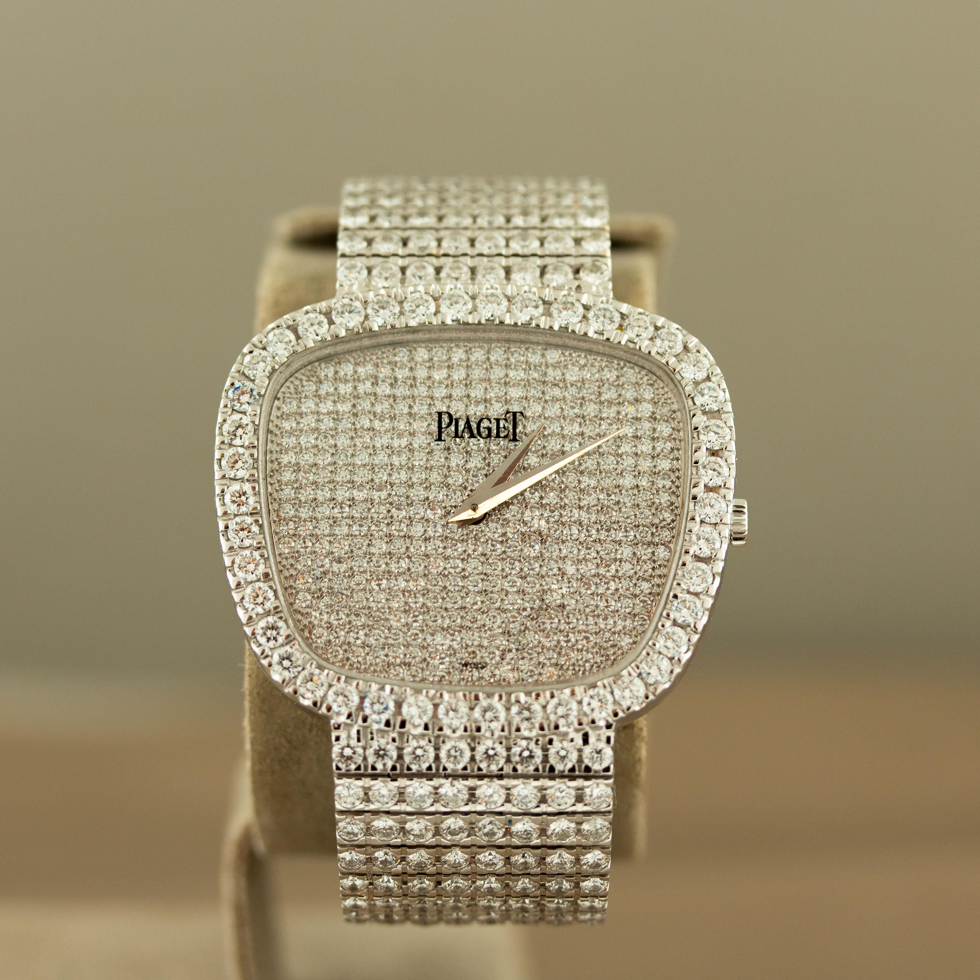containing 564 full cut diamonds [G/VS] weighing 13.05 carats total, and 344 pave set single cut diamonds [G/VS] weighing 1.72 carats total; the cushion shape minimalist dial signed ‘Piaget’ at 12:00 

Total diamond weight: 14.77 carats 

7 3/8
