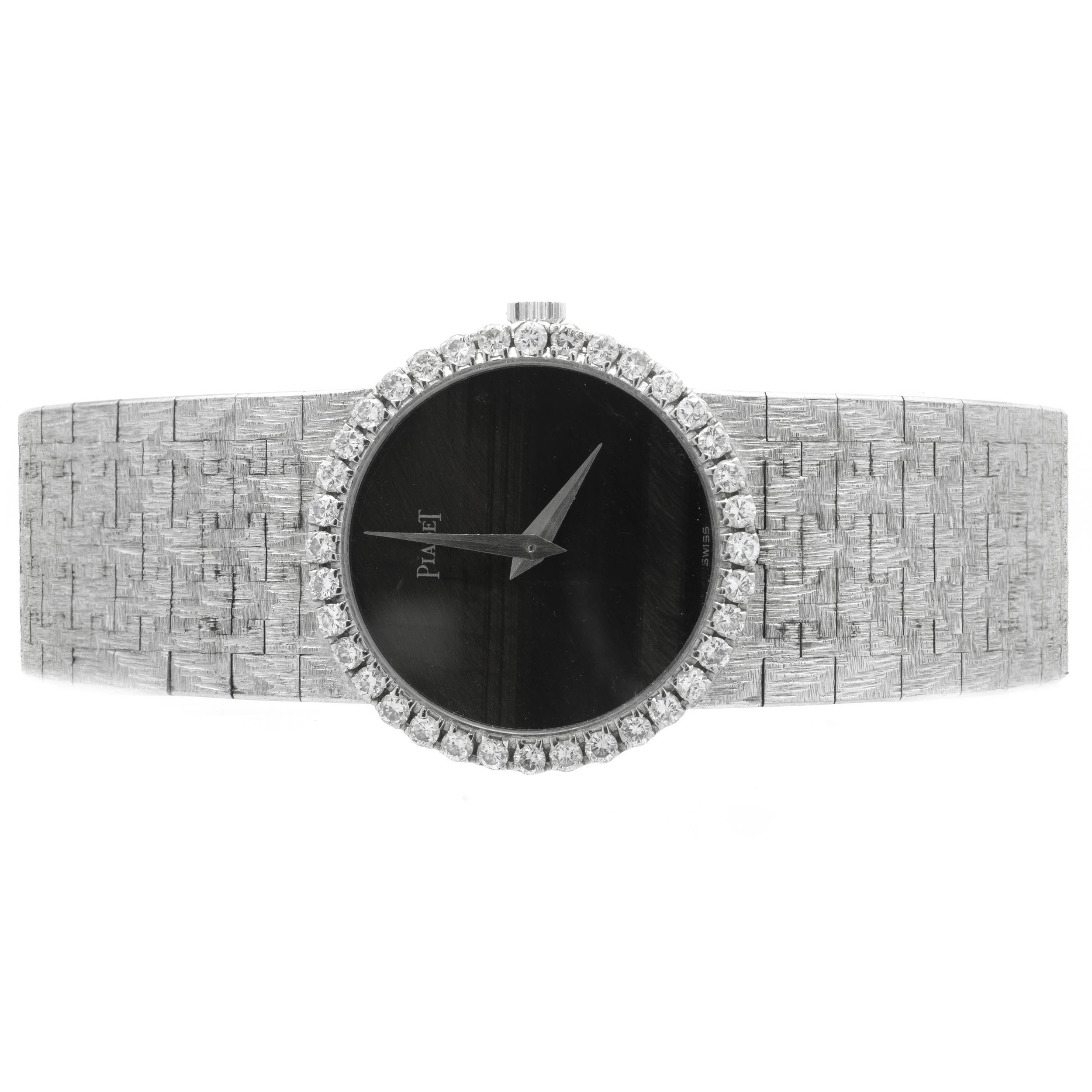 Movement: quartz
Function: hours, minutes
Case: 24mm 18K white gold case, diamond bezel,  scratch-resistant sapphire crystal, push/pull crown
Band: 18K white gold mesh bracelet
Dial: black tigers eye
Serial: 14XXX


Does Not Come with Box or