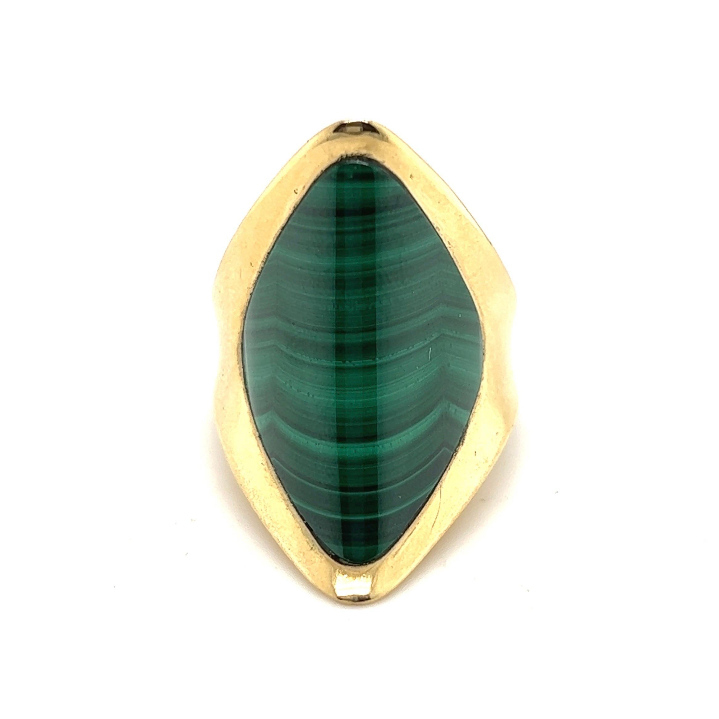 Stylish 18 karat yellow gold and malachite cocktail ring by Piaget, circa 1970s.

Crafted in 18 karat yellow gold, this attractive sculpural ring is set with a slightly concave lozenge-shaped malachite.
This beautiful pre-owned ring has been