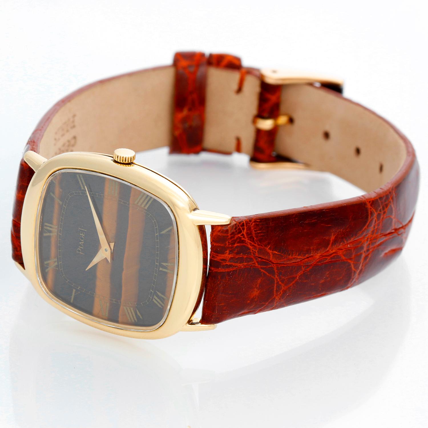 Piaget 18K Yellow Gold Tiger Eye Watch Ref. 9454 - Mechanical winding . 18K Yellow gold ( 27 x 36 mm ) . Tiger eye stone dial with Roman numerals . Brown alligator strap with 18K Yellow gold Piaget buckle . Pre-owned with custom box .