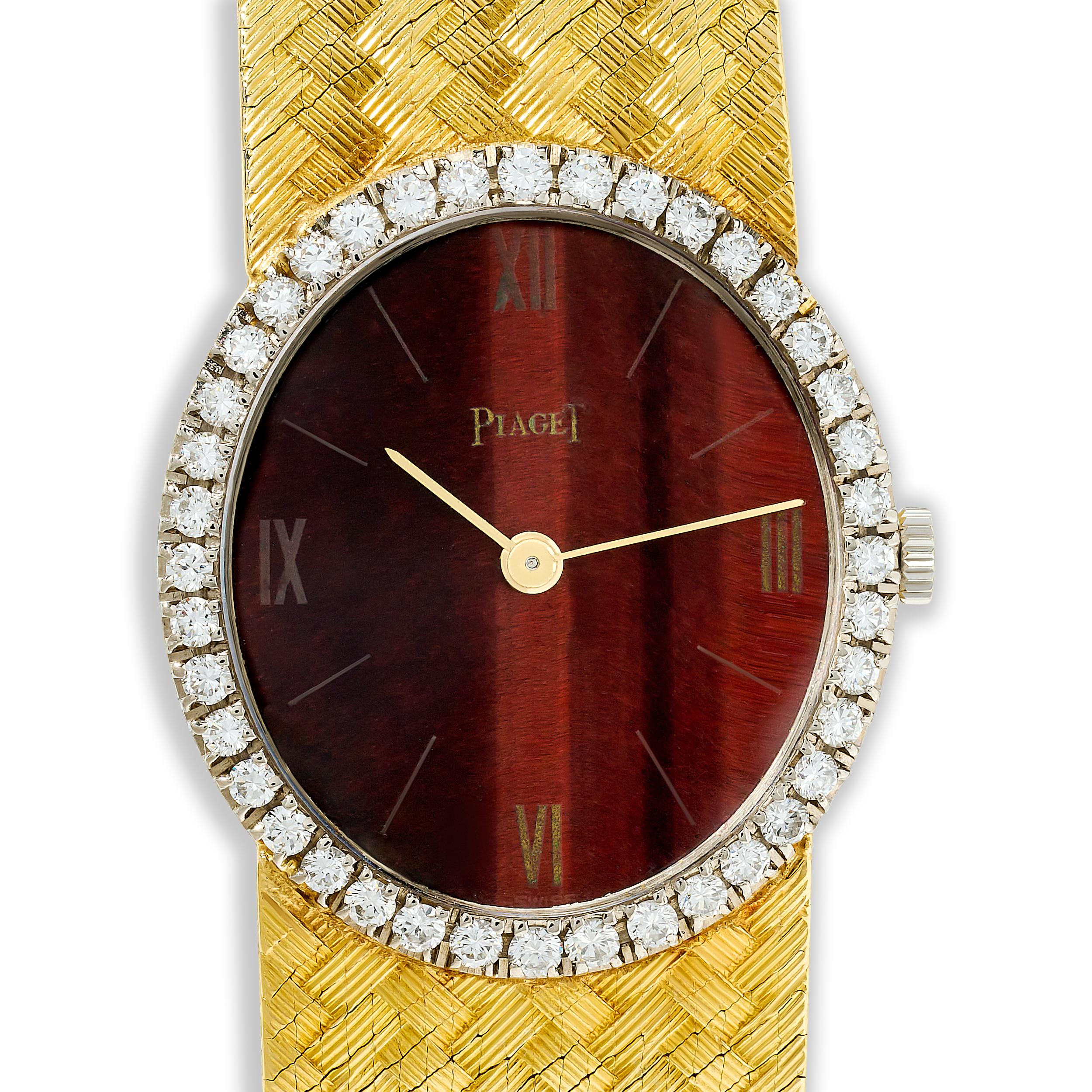 This Piaget watch features a captivating tiger's eye dial encircled by a sparkling diamond halo, all encased in 18 karat yellow gold with a woven bracelet, exuding a luxurious and timeless elegance.

40 round diamonds that weigh approximately 0.60
