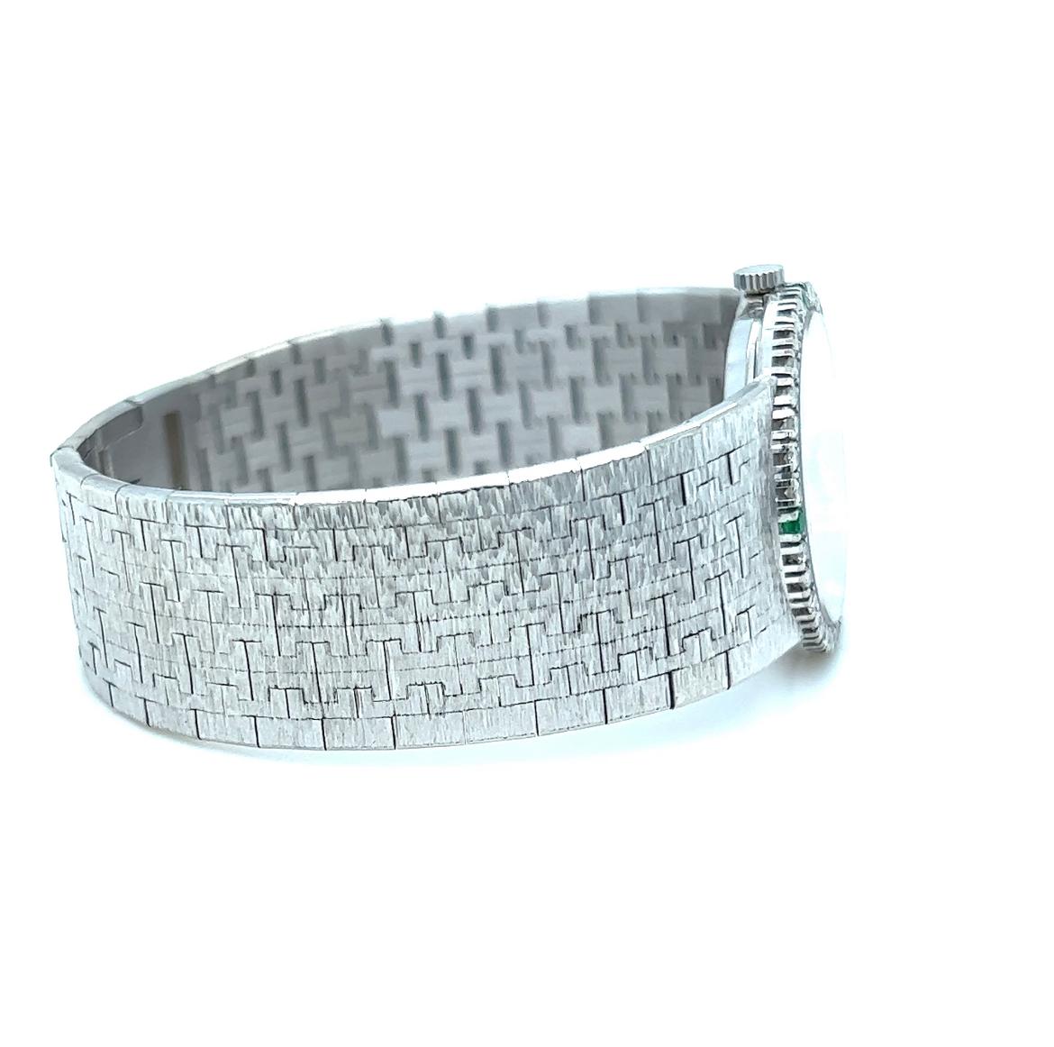 PIAGET  REF 9706 A 6, A WHITE GOLD, DIAMOND AND EMERALD SET BRACELET WATCH CIRCA 1990
Description
PIAGET

REF 9706 A 6
A WHITE GOLD, DIAMOND AND EMERALD SET BRACELET WATCH 

Dial: nephrite 
Caliber: manual winding jeweled movement
Case: 18k white