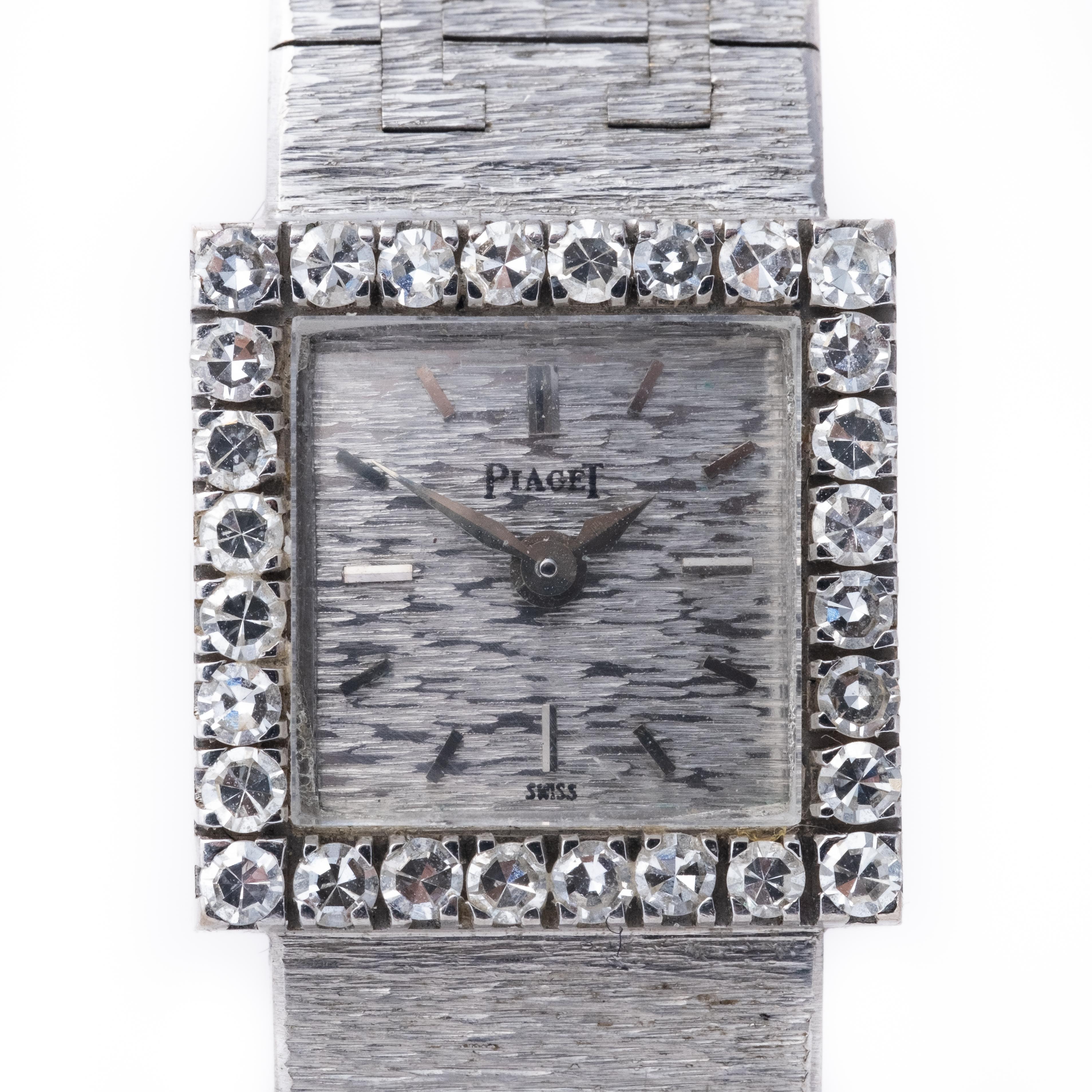 This is the classic piaget design diamond wristwatch .. The bezel is adorned with 28 single cut diamonds, and the dial has a textured finish and applied baton numerals. The watch is powered by a manual wind movement, and it comes with an integrated