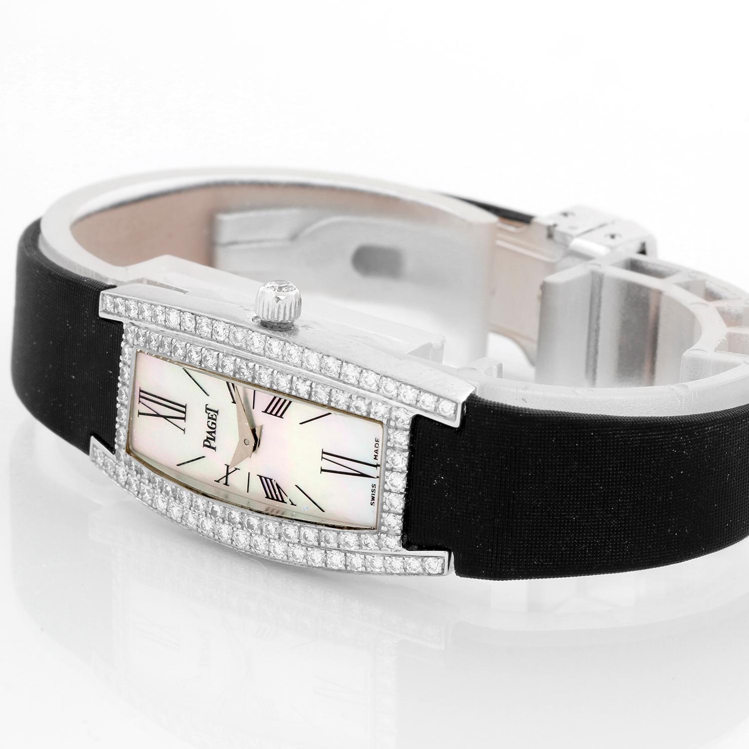 Piaget 18K White Gold Diamond Limelight Wrist Watch - Quartz. 18K White gold with diamond bezel ( 17 x 32 mm ). Mother of Pearl Piaget dial. Piasoie strap with diamond buckle. Pre-owned with Piaget box .
