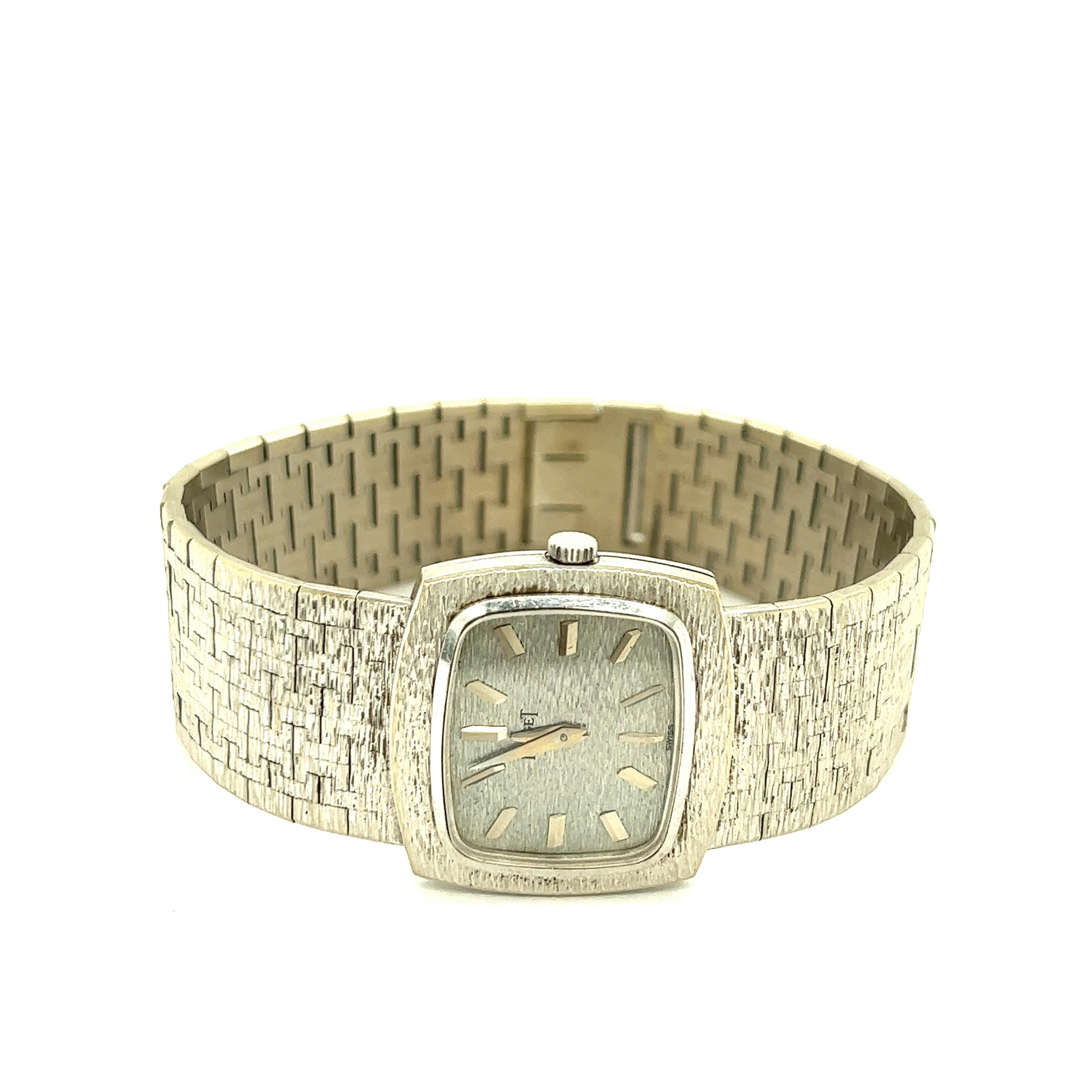 Piaget 18k White Gold Lady's Wristwatch

Rectangular shaped case with rounded corners, 18 karat white gold, with the classic Piaget surface finish on the straps, mechanical movement; marked Piaget, reference no. 9561A6, serial no. 199022, 750,