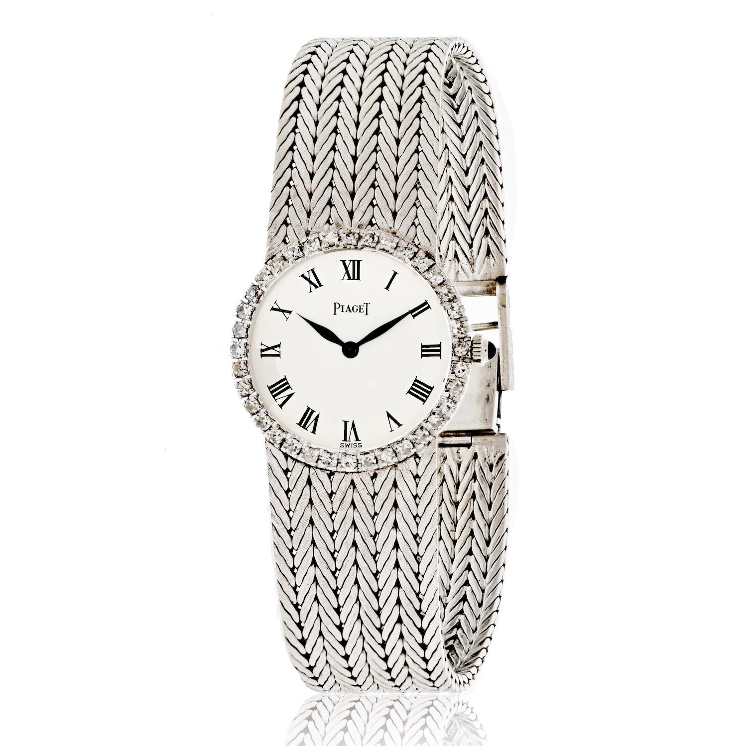 Ladies Piaget Watch with Roman Numeral White Dial and Diamond Bezel.

A ladies 18K white gold Piaget wristwatch featuring a white enamel dial with Roman numerals. Surrounding the dial is a bezel set with 36 round brilliant cut diamonds weighing a
