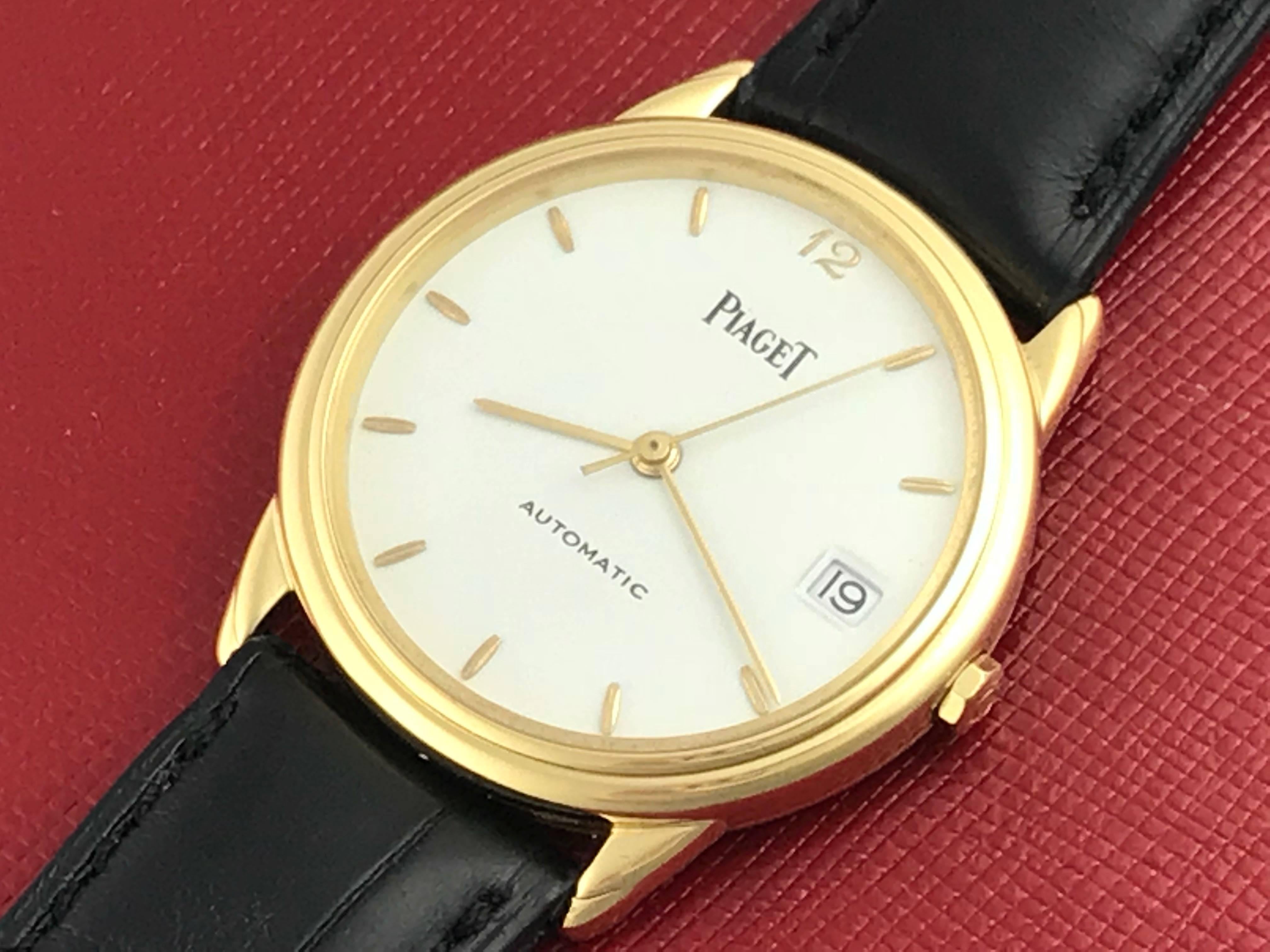 Piaget Mens 18k yellow gold automatic strap wrist watch. 18k Yellow Gold round style case (34mm dia.), Dark brown alligator strap with yellow gold filled buckle,  White Dial with yellow gold hour markers. Certified Pre Owned and ready to