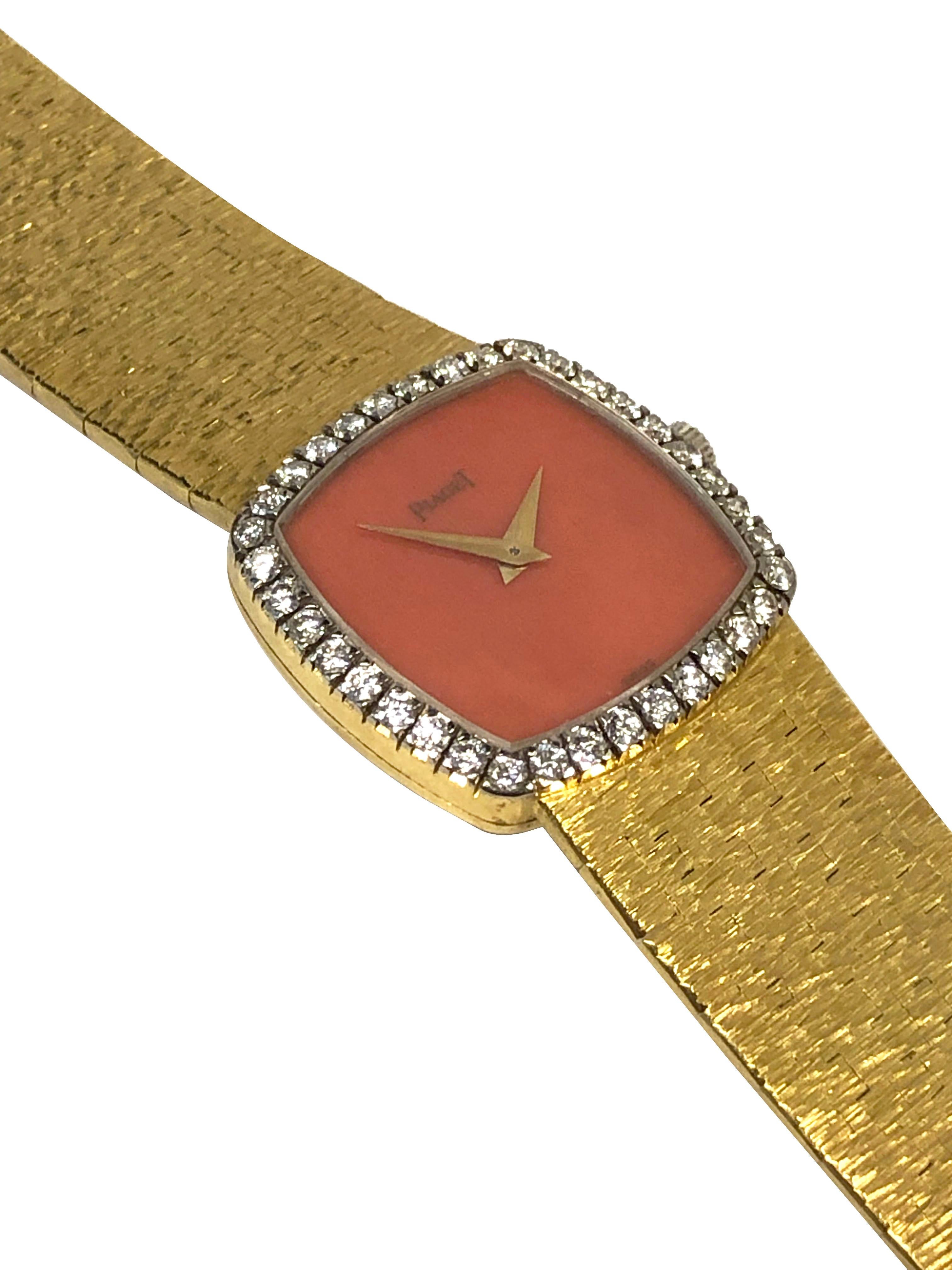 Circa 1970s Piaget Ladies Wrist Watch, 22 x 22 M.M. 18k Yellow Gold 2 piece case, Piaget Factory set Diamond Bezel of Round Brilliant cut Diamonds totaling approximately 1 carat. 17 jewel, mechanical, manual wind movement, Coral dial. 5/8 inch wide