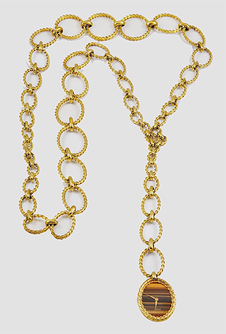 Piaget 26mm Sautoir Link Necklace Watch in 18k Yellow Gold.
A sautoir opera-length link necklace by Piaget with a timepiece as its extending ornament. The links are carefully constructed with twisted reeds of gold, which graduate in form several