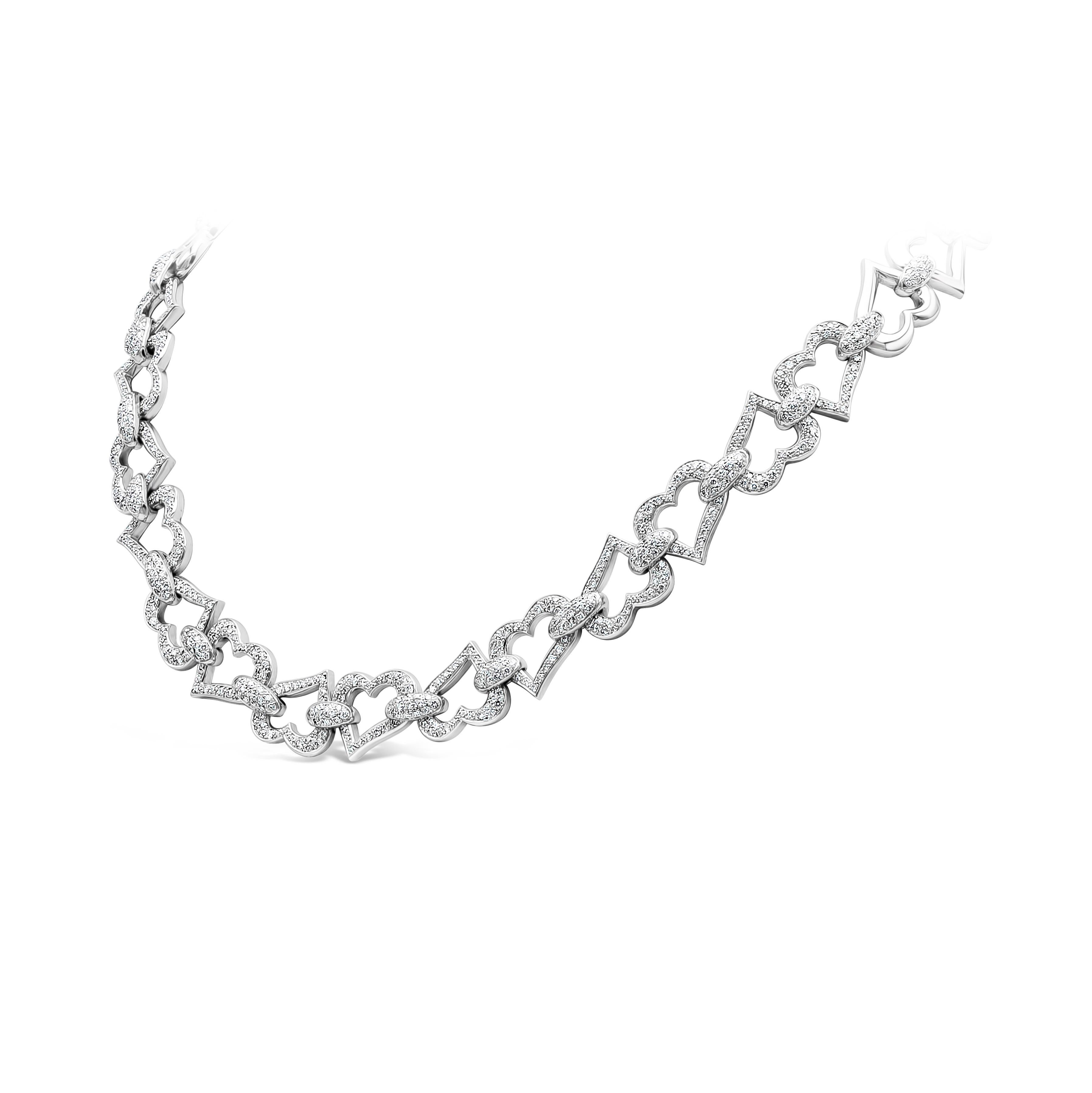 This unique charmingly splendid heart shape link necklace features 653 pieces of round shape diamonds weighing 5.80 carats total, D-F in Color and VVS+ in Clarity. The heart shape diamonds are approximately 0.51 inches wide. Made with 18k Gold.