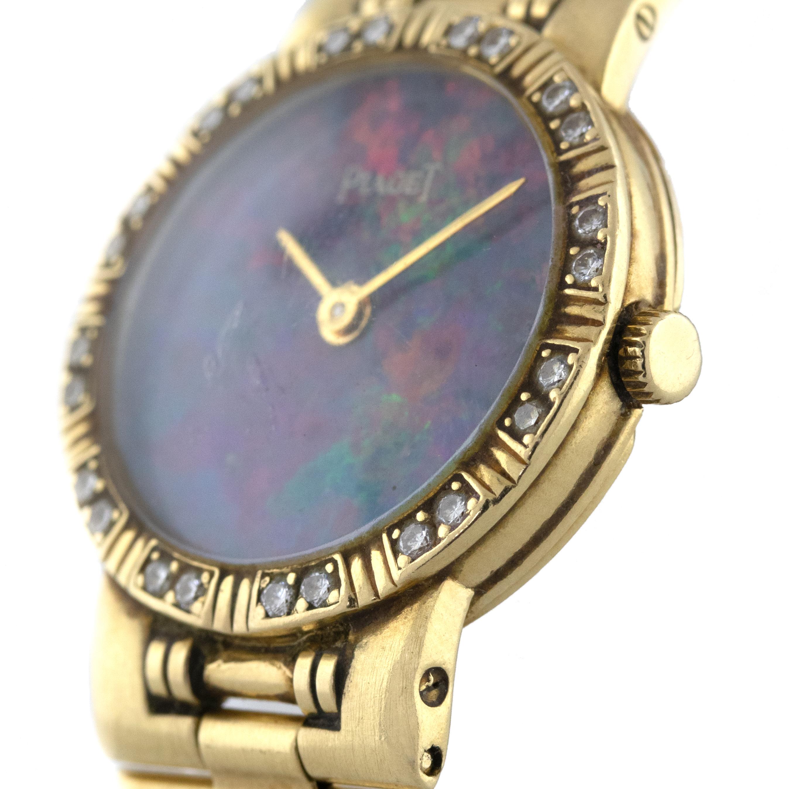 Brand: Piaget
Case Material: 18k yellow gold
Case Diameter: 23mm
Crystal: Plastic
Bezel: Factory 18k Yellow Gold with Diamonds
Dial: Factory Opal Dial
Bracelet: 18k Yellow Gold Bracelet
Size:  Will fit a 6 wrist
Clasp: 18k Yellow Gold Jewelers
