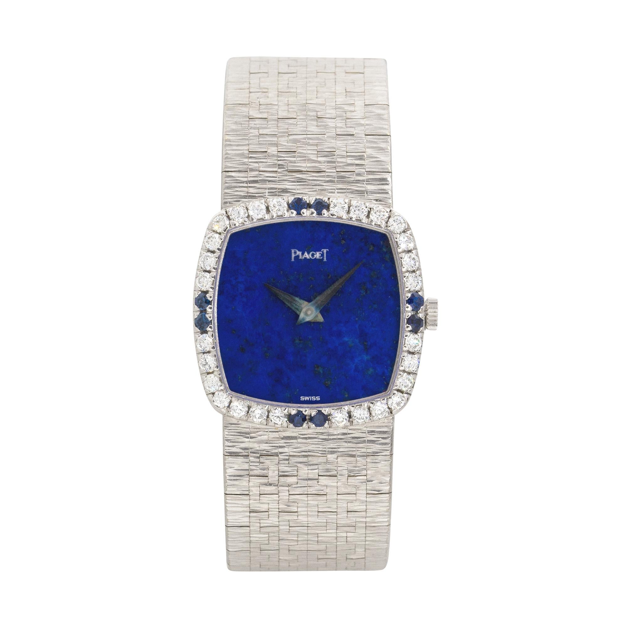 Brand: Piaget
Case Material: 18k White Gold
Case Diameter: 23mm
Crystal: Sapphire Crystal
Bezel: 18k White Gold Diamond and Sapphire bezel
Dial: Blue dial with silver hands
Bracelet: 18k White Gold bracelet
Size: Will fit a 5