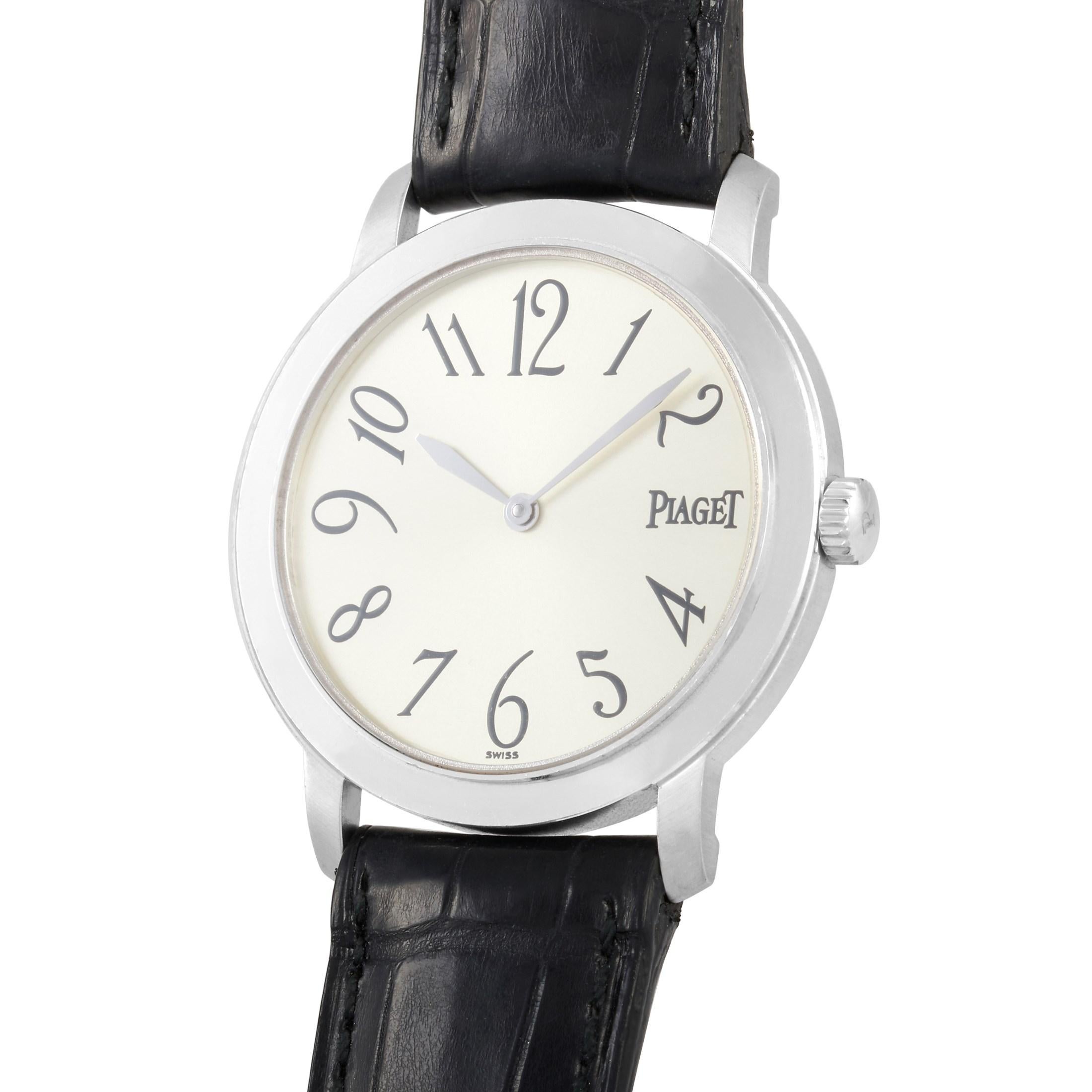 This Piaget Altiplano 18K White Gold 34mm Watch, reference number 850215, comes with a 18K white gold case that measures 33 mm in diameter. The case is presented on a black crocodile leather strap with tang clasp. The solid case back features the