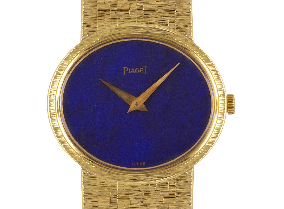 A 27mm manual winding women's dress wristwatch, by Piaget. 

A fixed 18k yellow gold textured bezel holds in place a sapphire crystal, which showcases a deep blue lapis lazuli dial; the universal stone to symbolise truth and wisdom. 

A luxurious