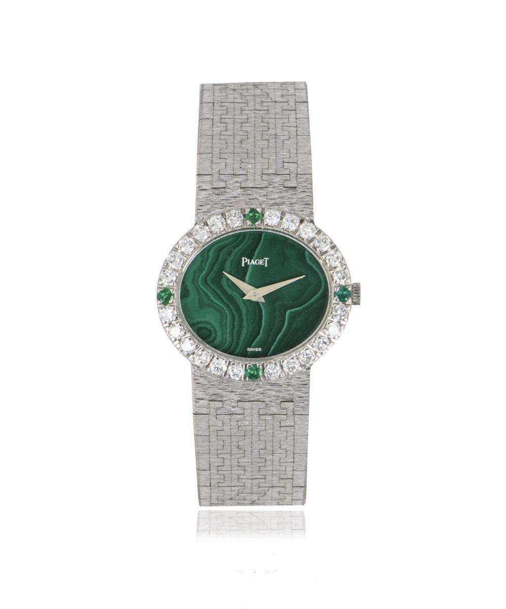 A classic ladies' Cocktail dress watch crafted in white gold, 26mm by Piaget. Featuring a unique malachite stone dial and a fixed white gold bezel set with 24 round brilliant cut diamonds and 4 round cut emeralds.

Fitted with a scratch resistant